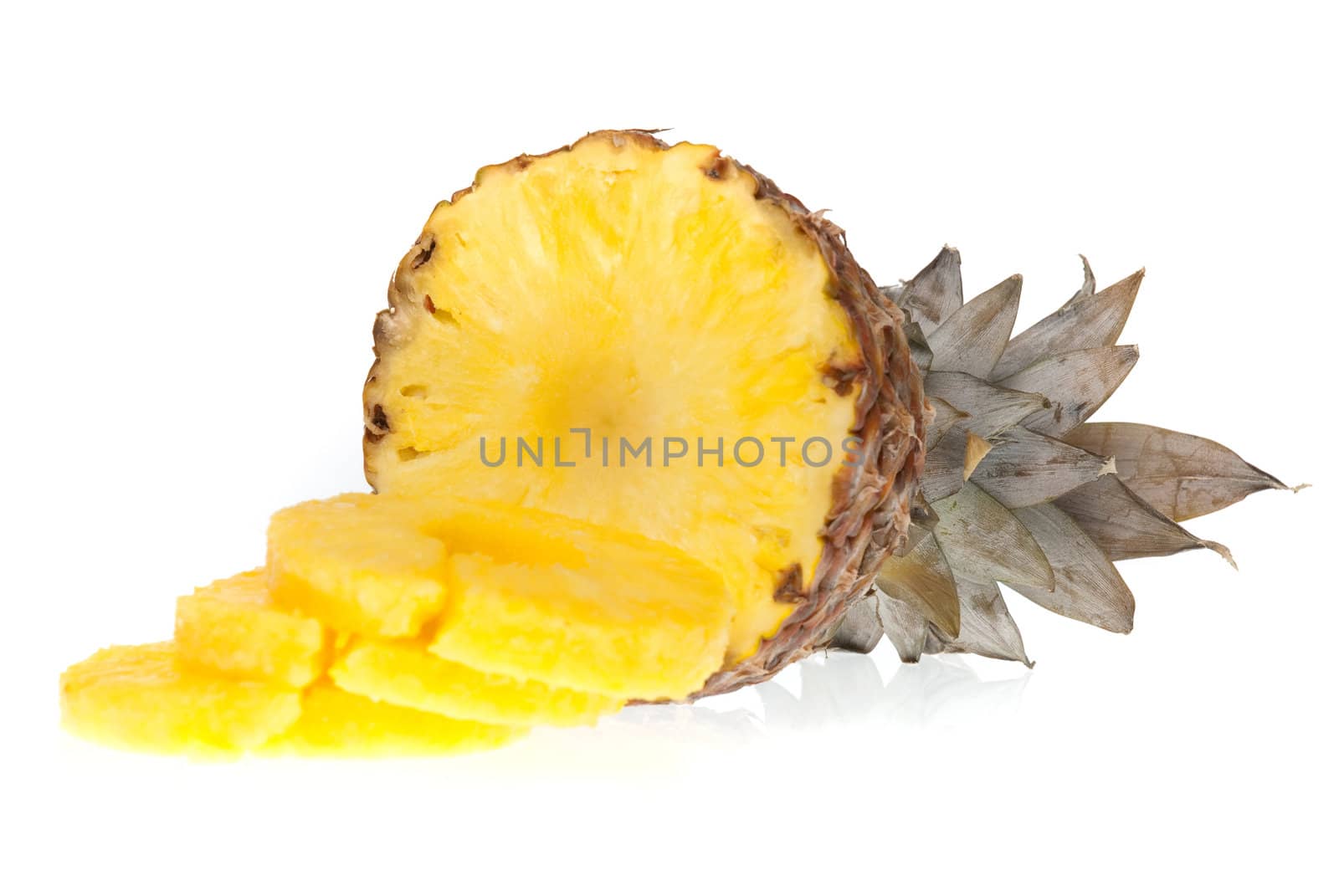 Ripe pineapple with slices isolated on white background.