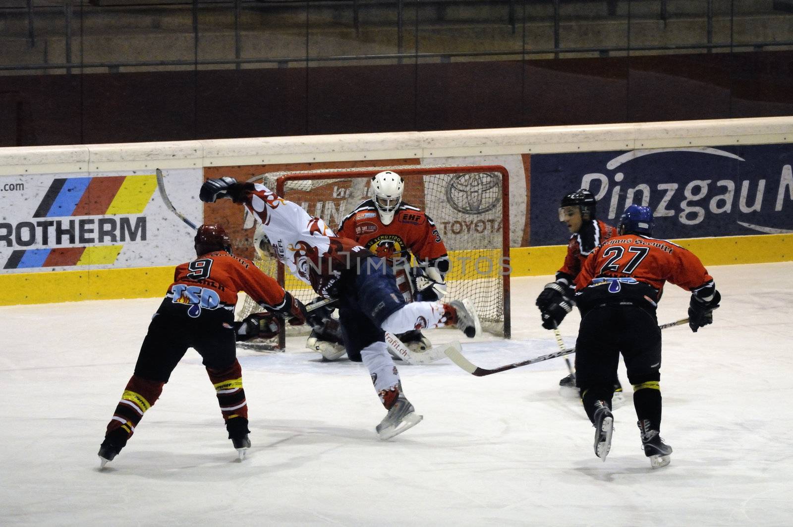 ZELL AM SEE, AUSTRIA - NOVEMBER 28: Salzburg hockey League. Thorsten Scharer tripping attacking Devils player. Game between SV Schuettdorf and Devils Salzburg  (Result 2-13) on November 28, 2010, at the hockey rink of Zell am See