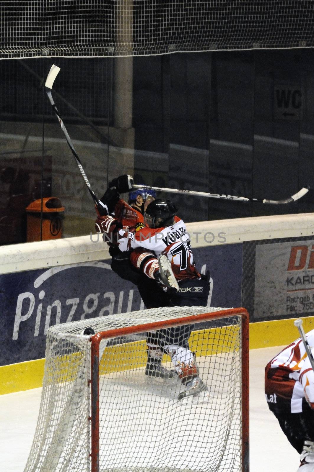 ZELL AM SEE, AUSTRIA - NOVEMBER 28: Salzburg hockey League. Devils Kuebler runs over Schuettdorf player. Game between SV Schuettdorf and Devils Salzburg (Result 2-13) on November 28, 2010, at the hockey rink of Zell am See