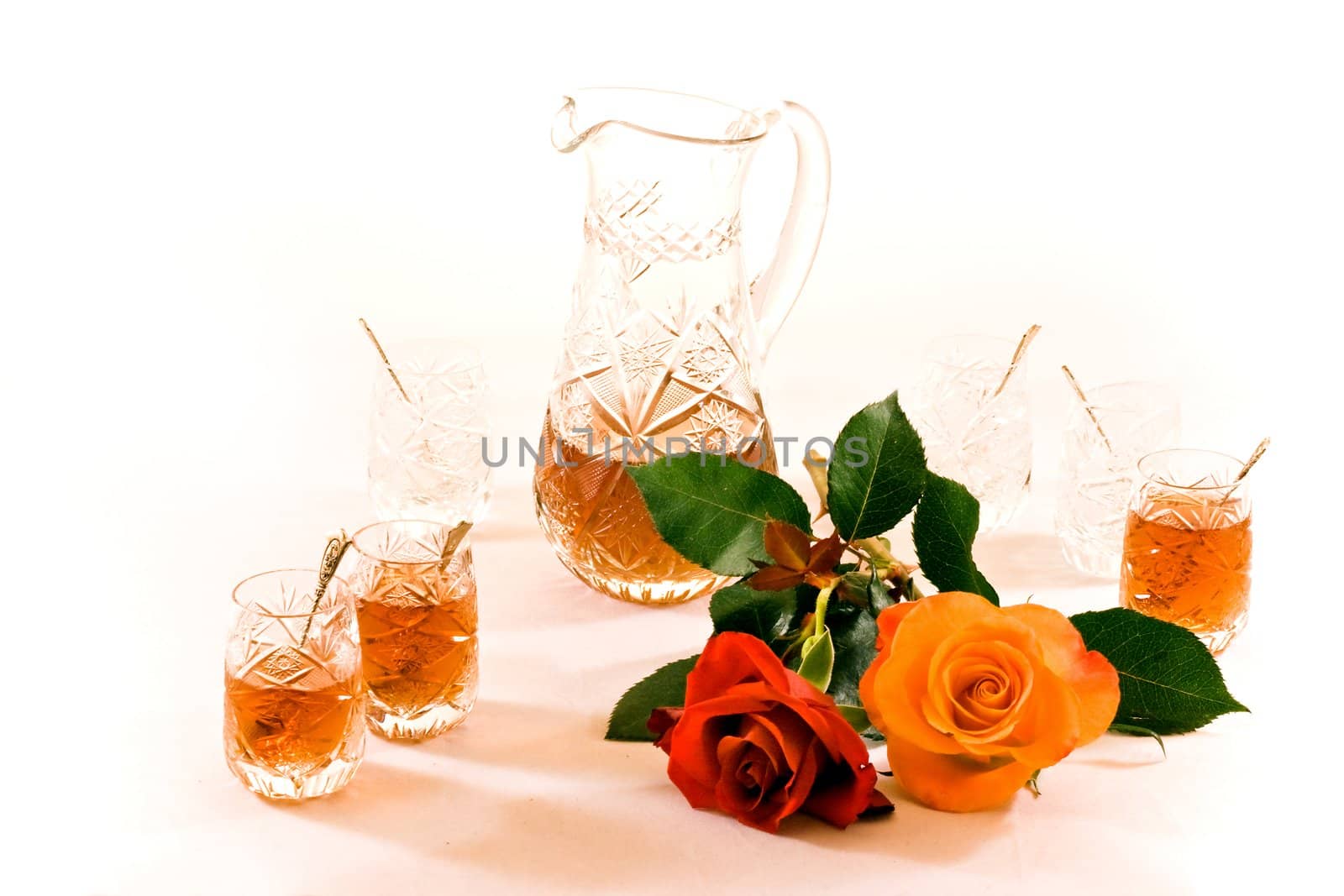 Turkish crystal teaset with can, tiny glasses and roses on white background