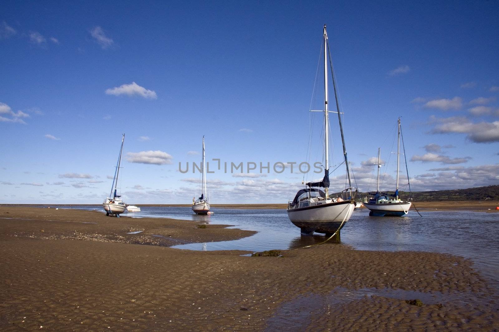 Yachts at anchor in Red Wharf Bay, Anglesey at low tide