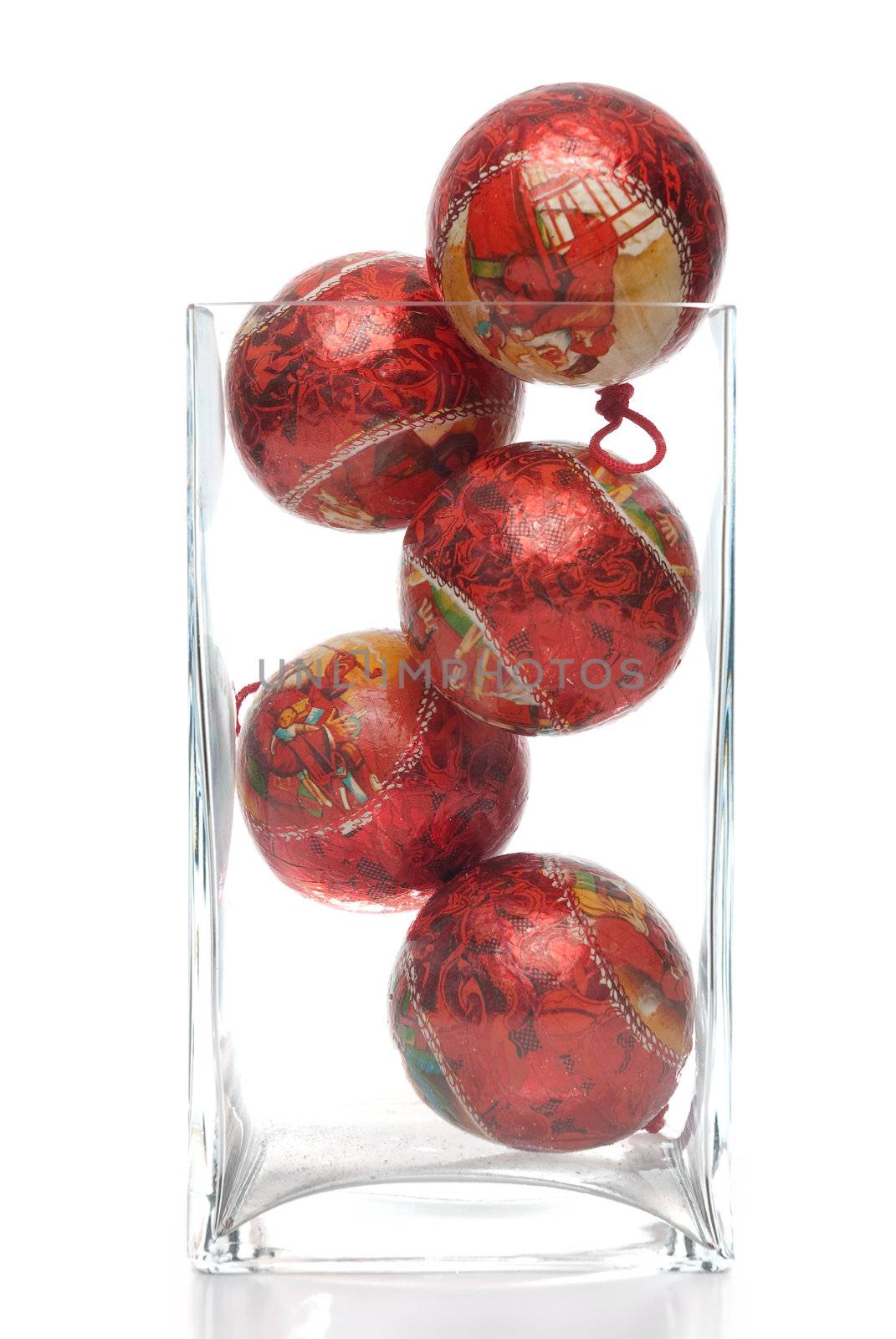 Christmas decorative balls in glass jar isolated on white background.
