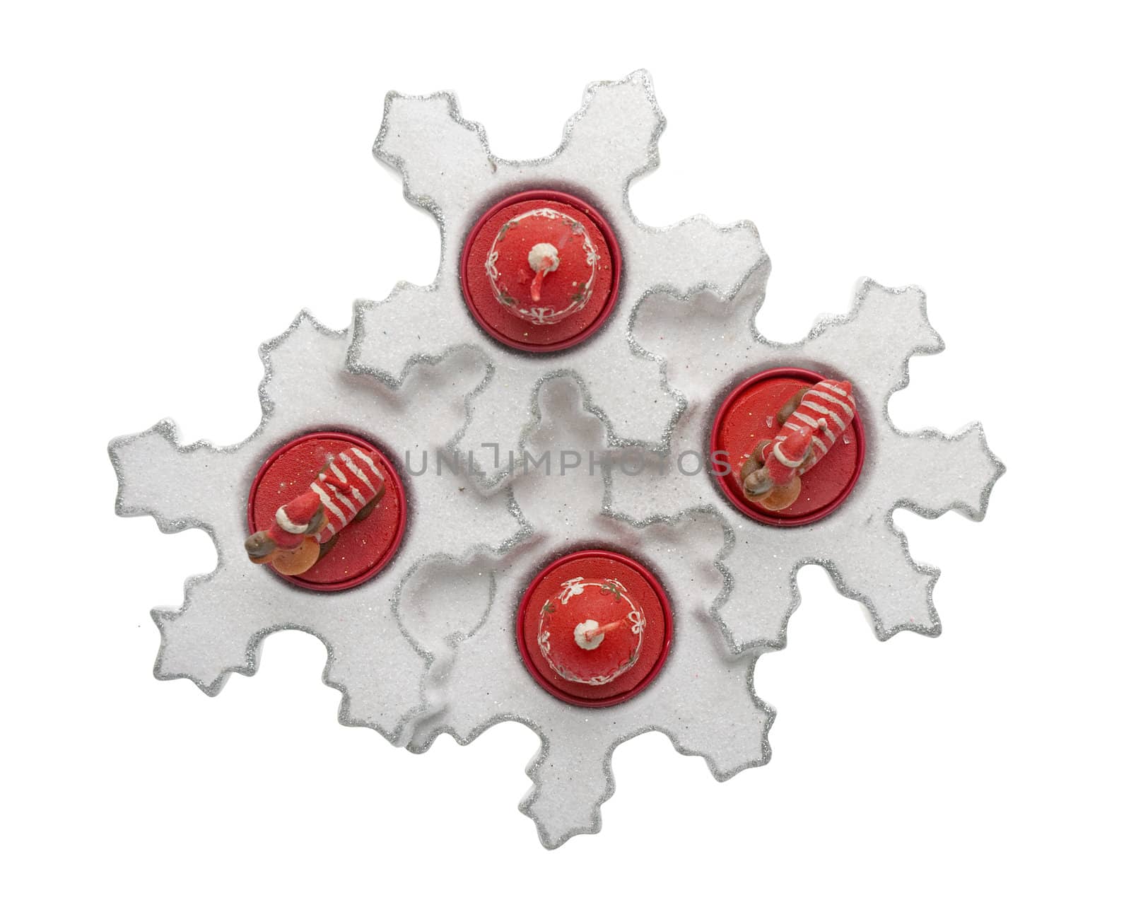 Christmas decoration with red wax candles on a white background.