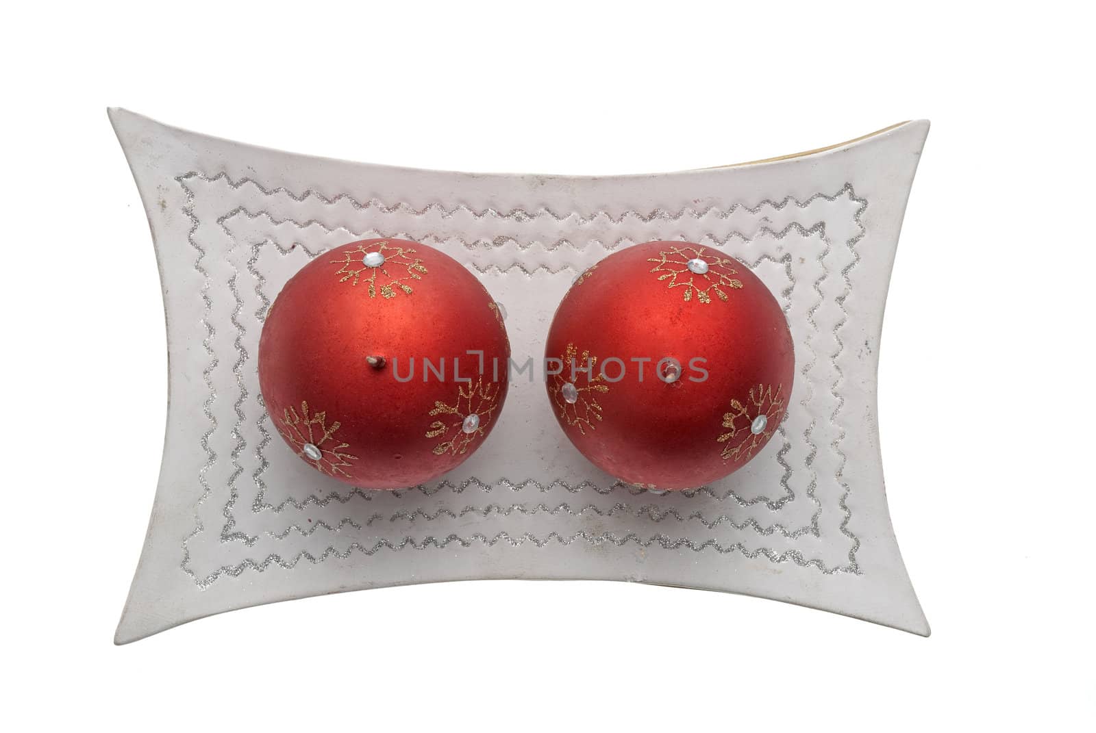 Christmas decoration with red wax candles on a white background.