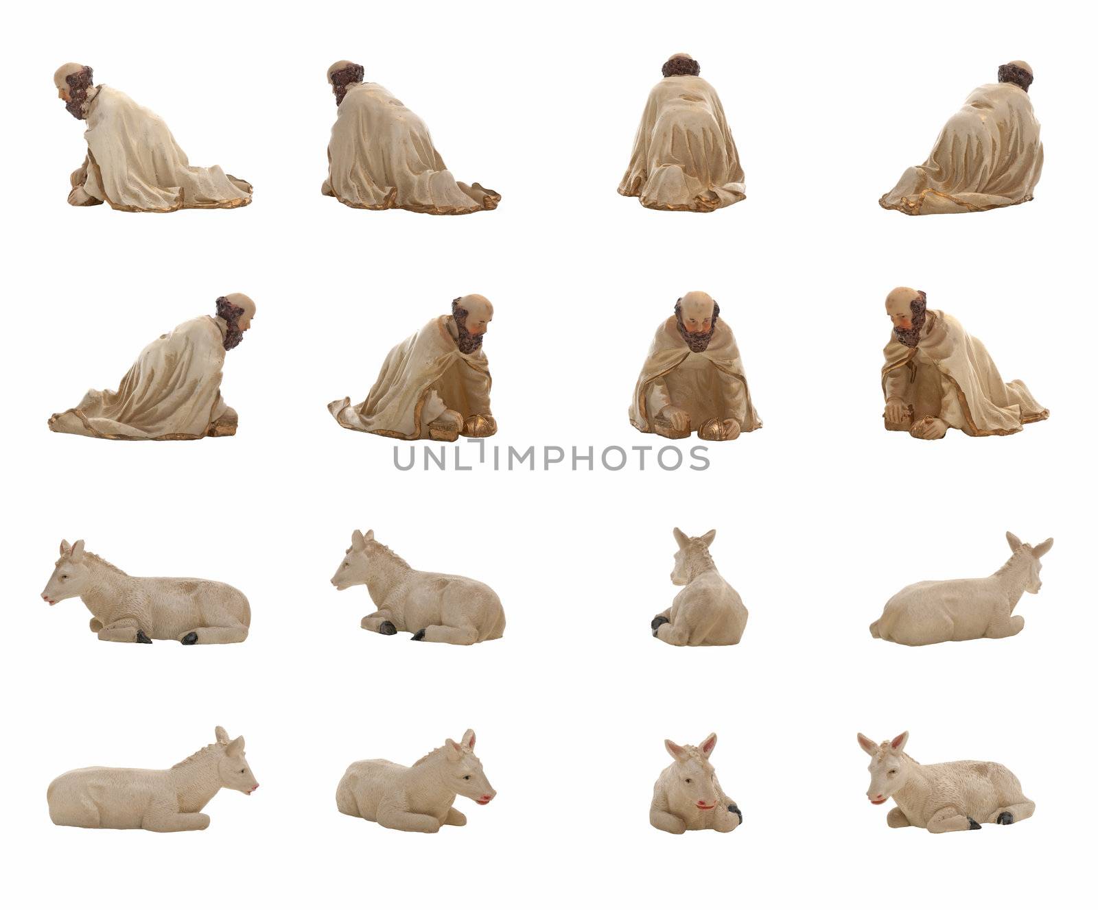 Christmas crib isolated on white statuettes representing a King and a donkey.