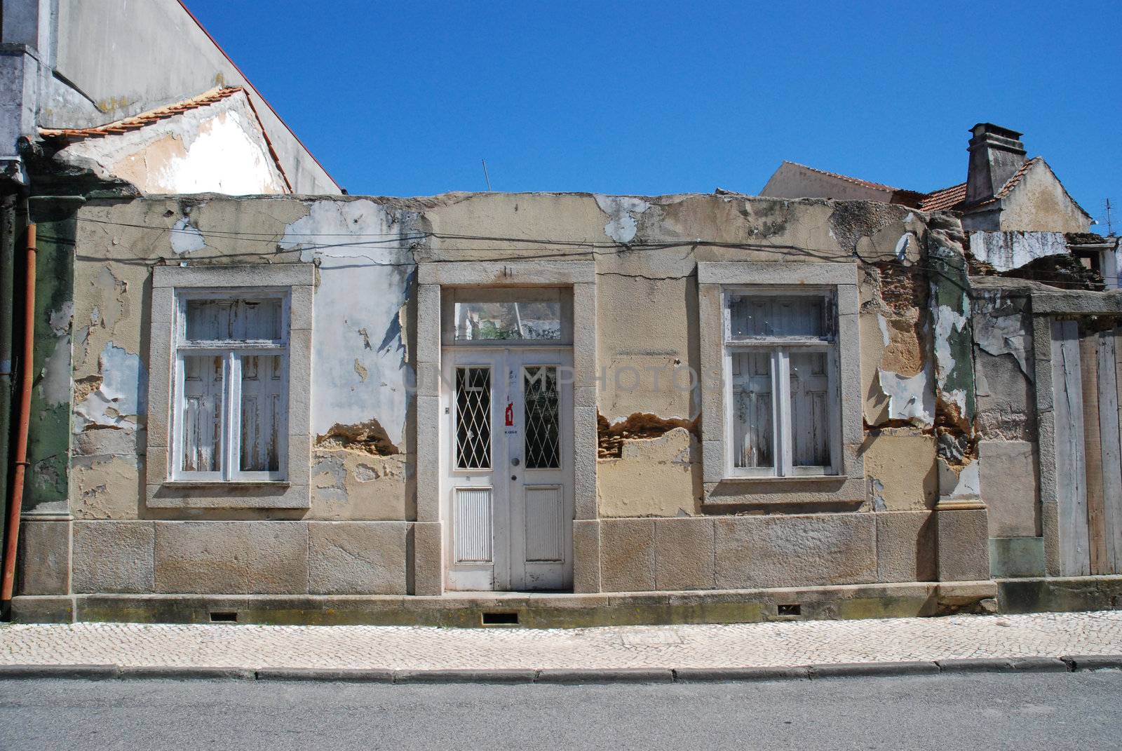Old house facade with no roof on a blue sky background.