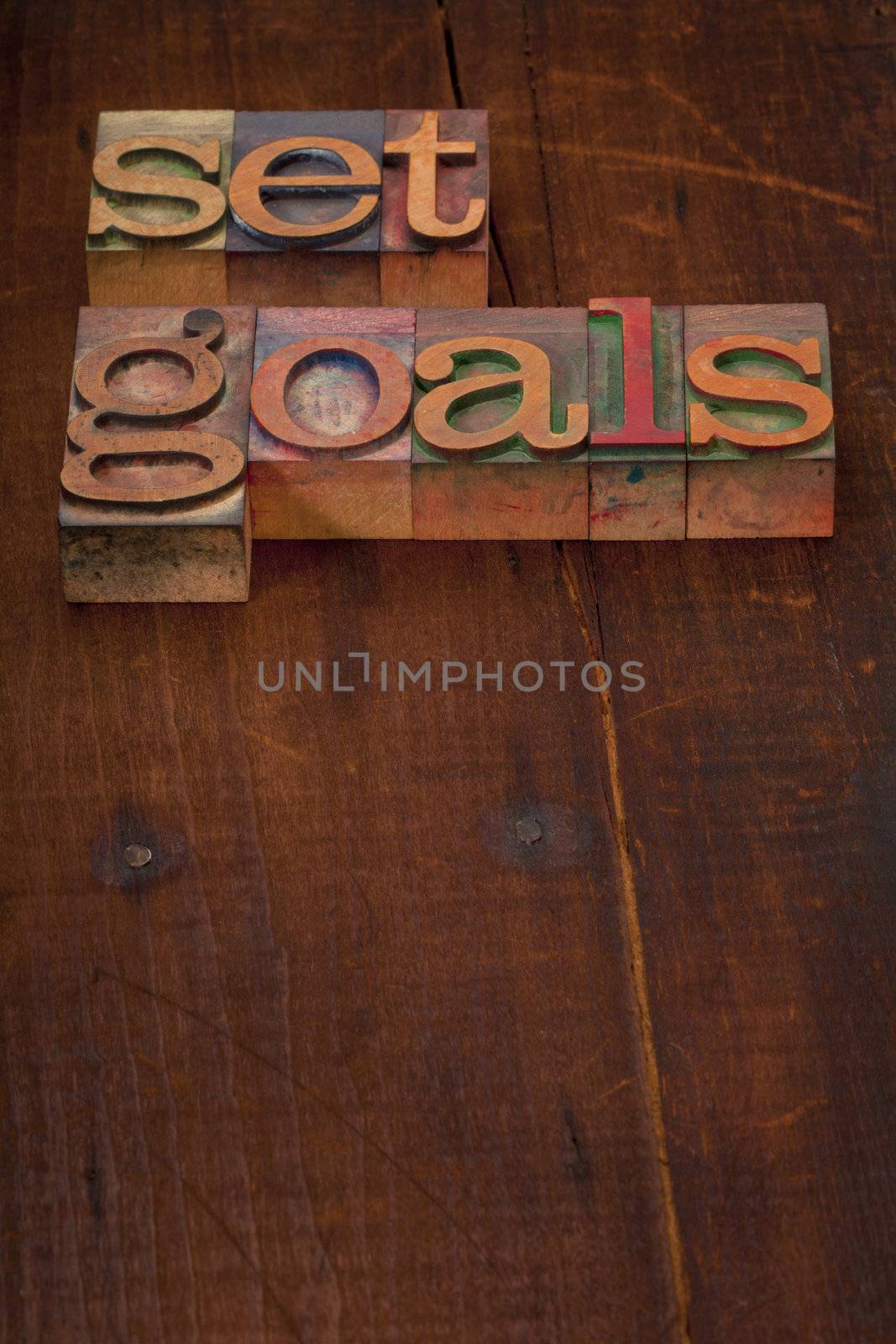 set goals - text in vintage wooden letterpress printing blocks against old grunge wooden background