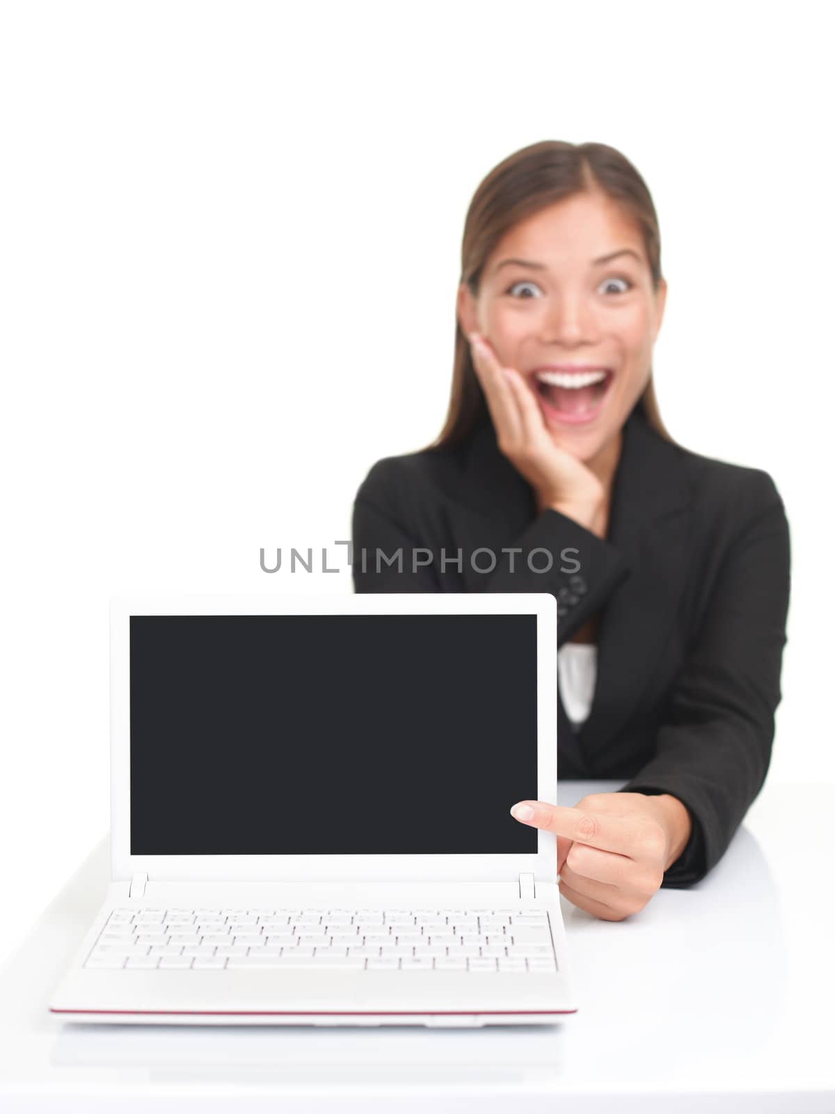 Laptop woman pointing excited at netbook screen with blank copy space. Isolated over white background.
