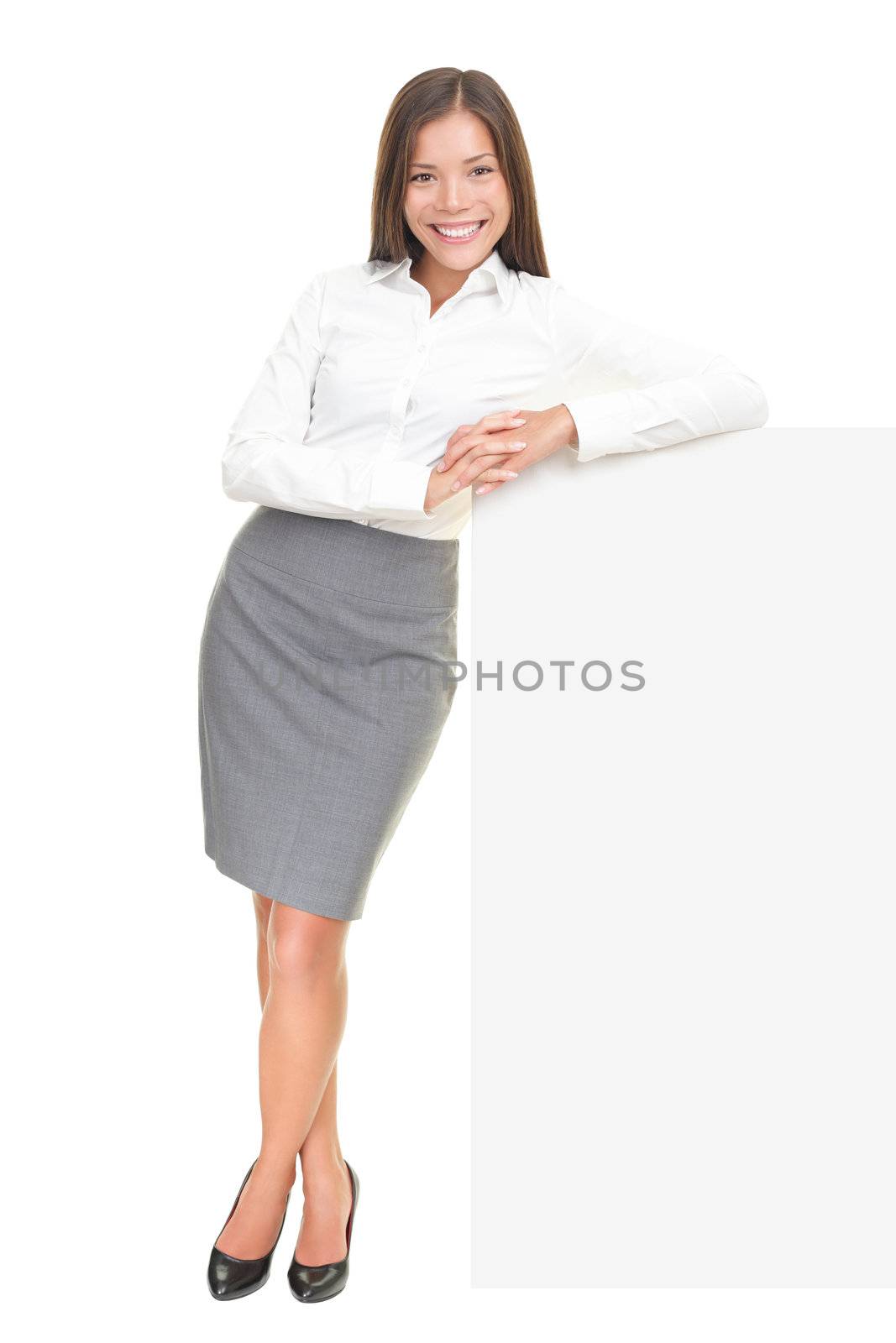 Beautiful business woman leaning on billboard sign in full length isolated over white background. Asian / Caucasian female model.