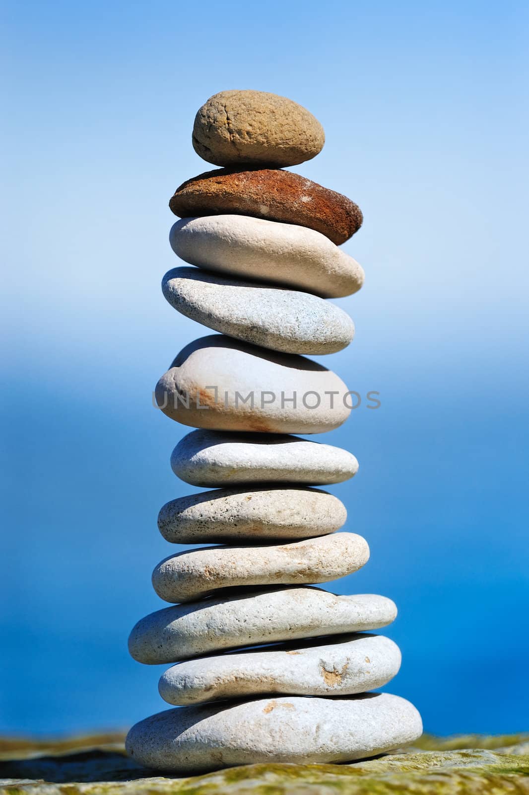 Tallest tower of marine gravel on the background of the sky