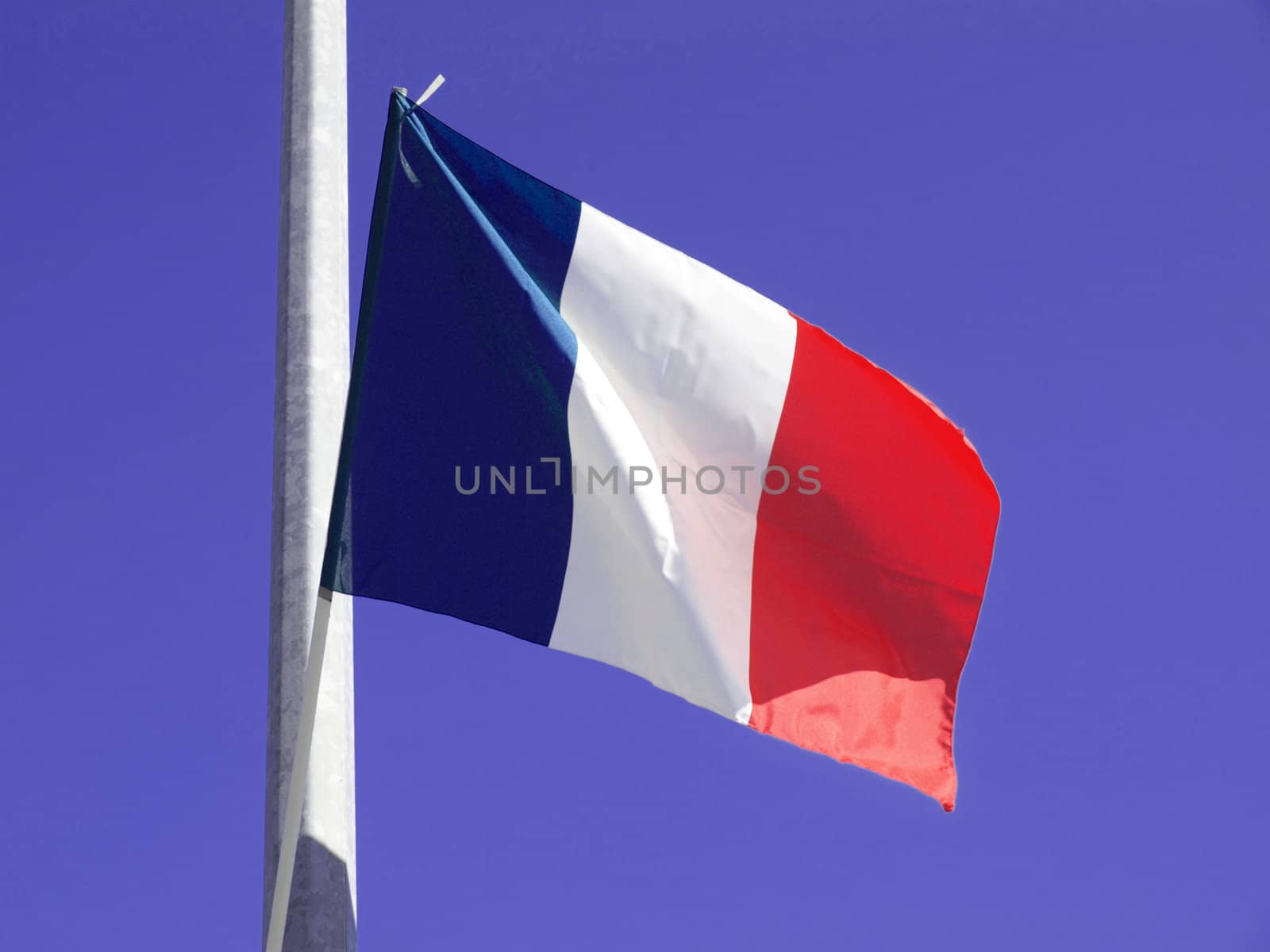 Flag of France over blue sky background