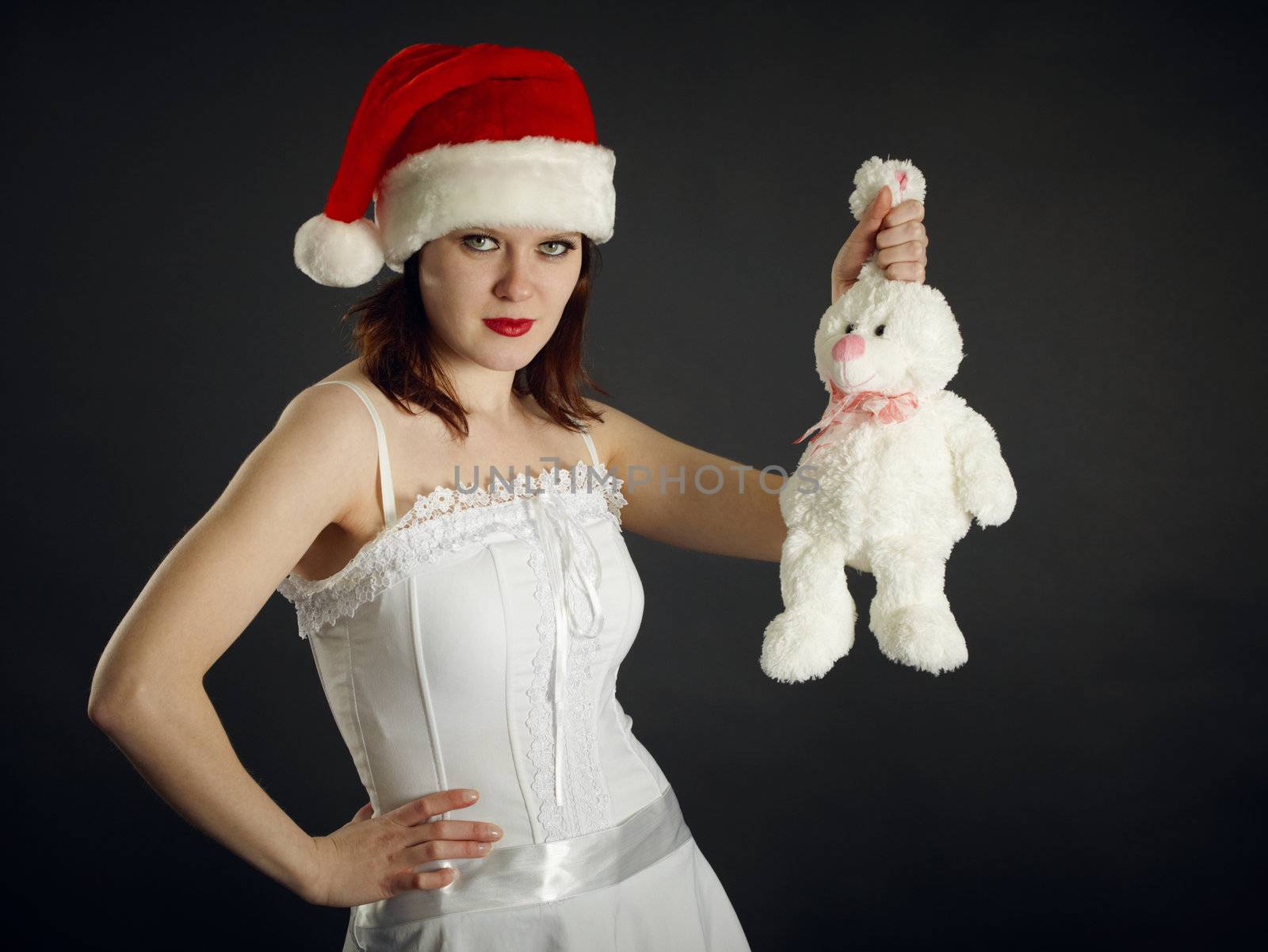 Young woman in Christmas cap holds a rabbit by pzaxe