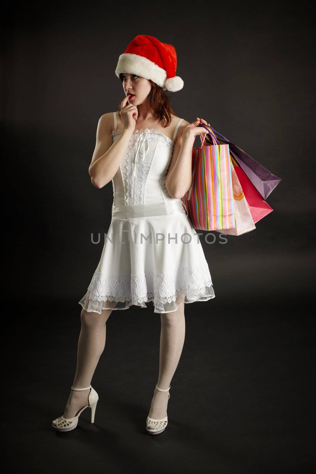 The young woman in New Year's clothes thinks of the next purchase