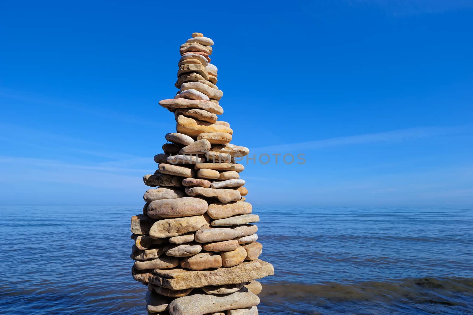 Pile of pebble as the tower on the sea coast