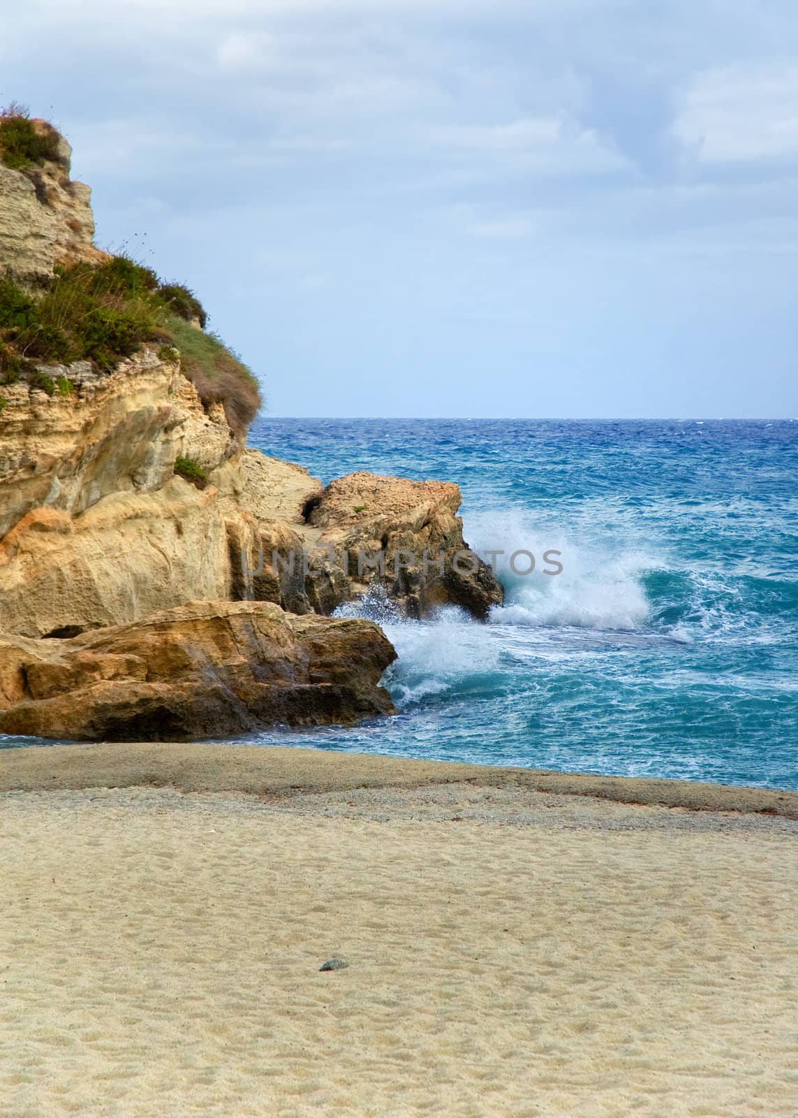 Shot taken in Tropea, Calabria, Italy. Church on rocks with sea and boat on beach. Copy space.