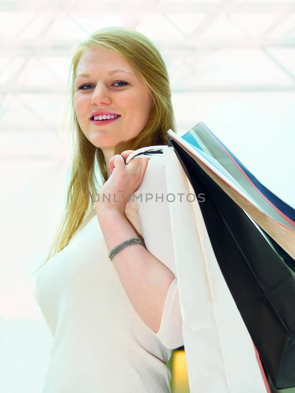 Smiling young shopper looking down at you