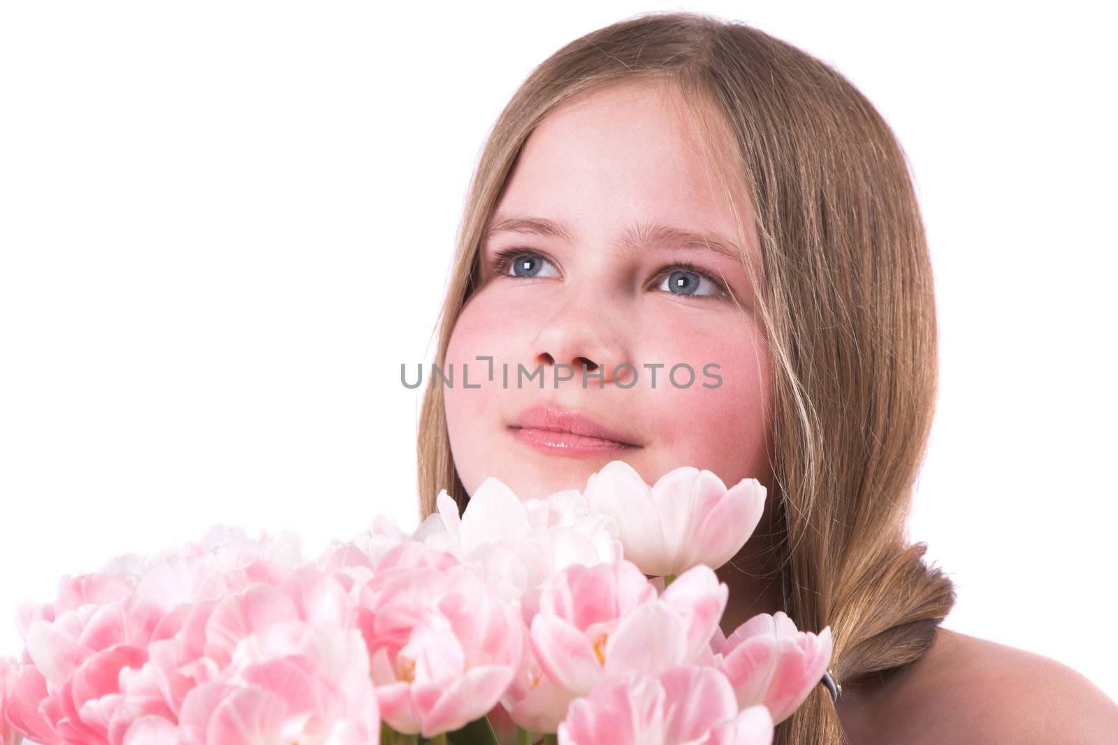 Beautiful little girl giving a bouquet of pink tulips