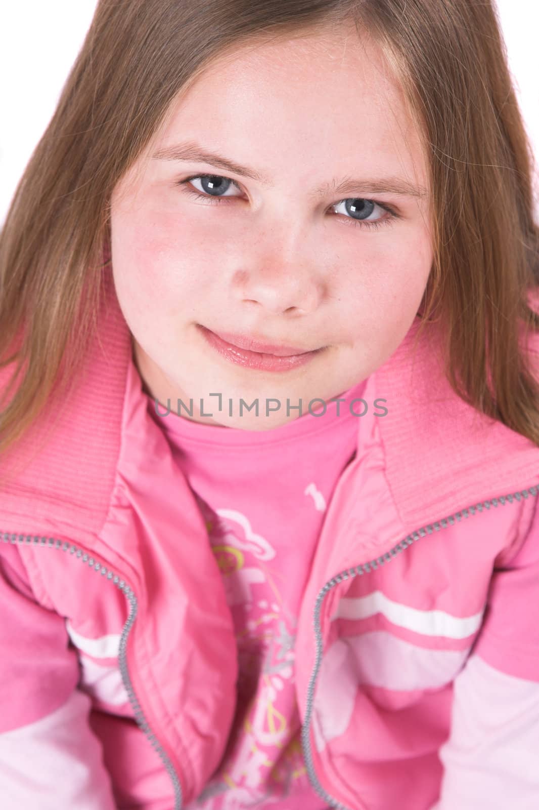 Pretty ten year old girl looking up dressed in pink