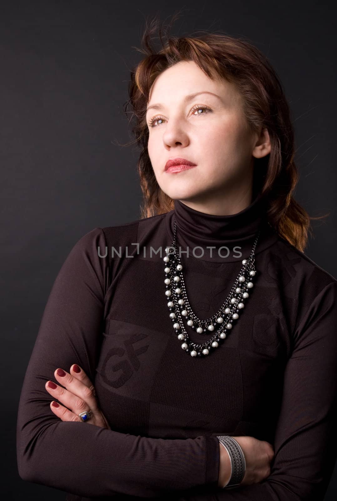 Portrait of the woman in studio on a black background.