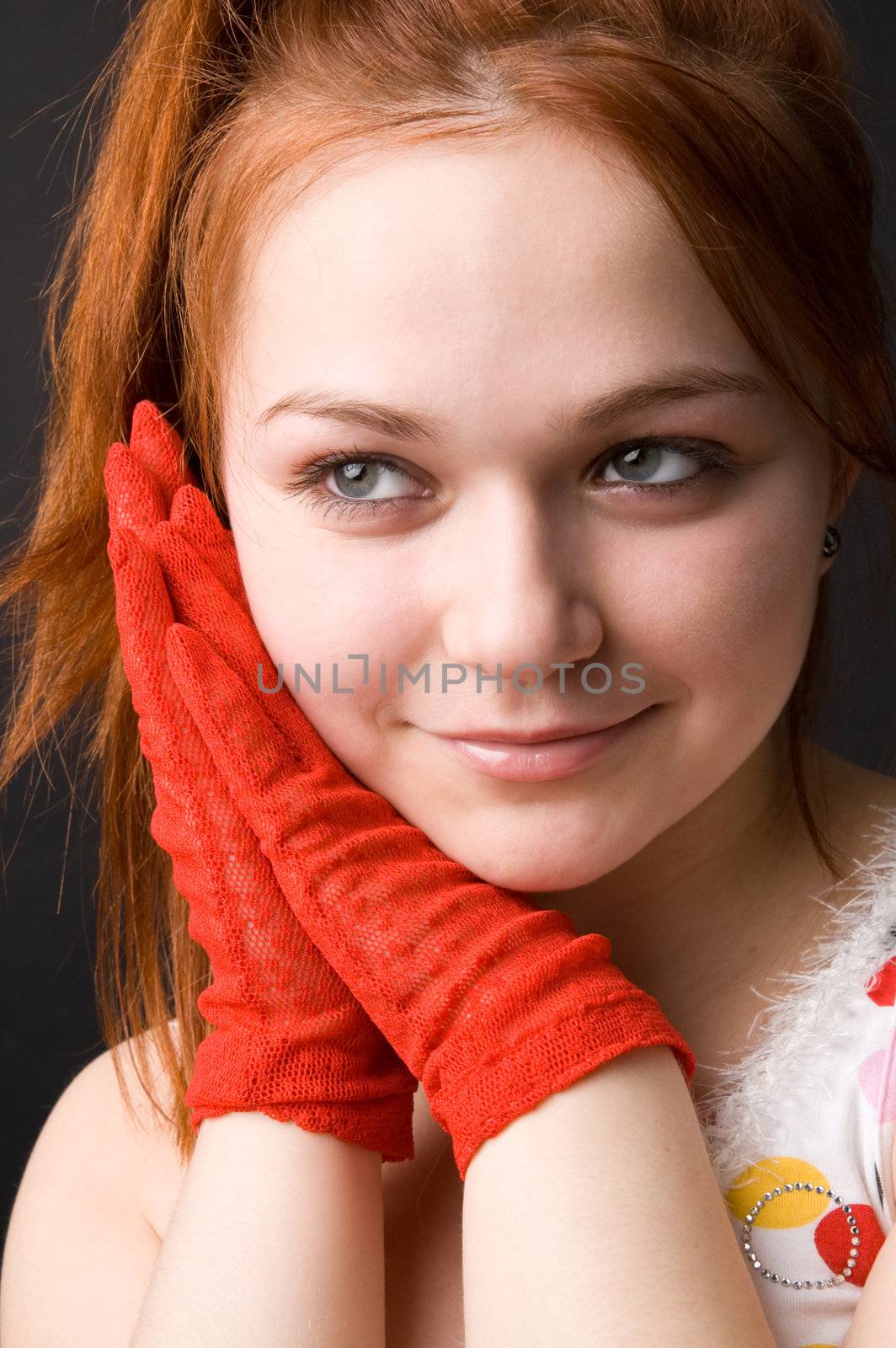 The charming young girl in studio on black background