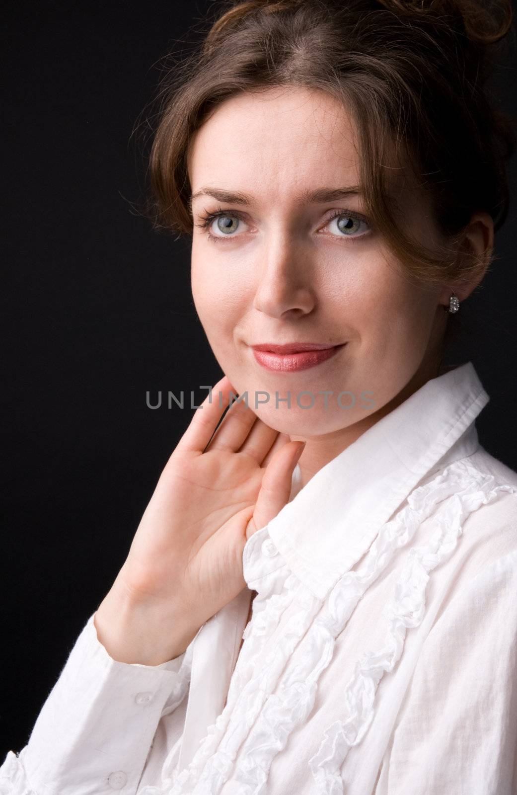The beautiful girl in studio on a black background.