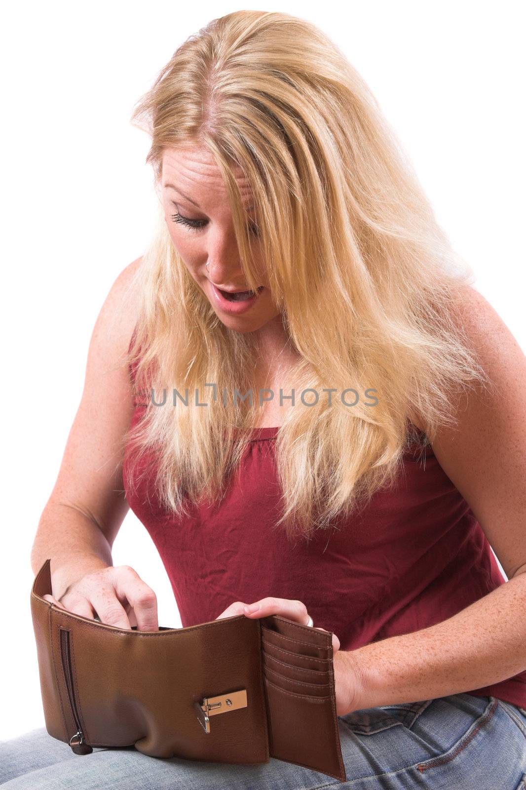Pretty blond woman looking into her wallet and finding more then she expected