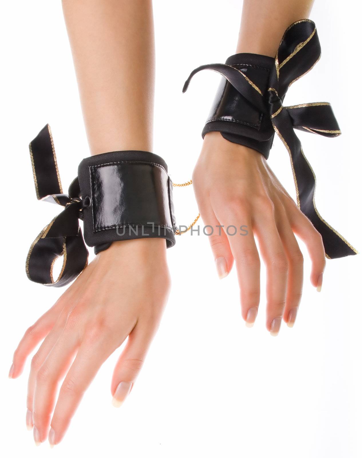 Leather handcuffs with golden chains on isolated background