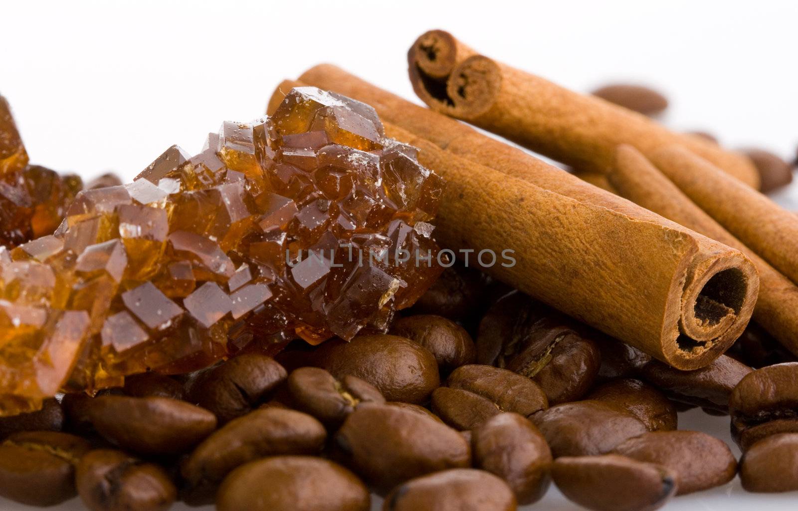 Isolated coffee beans, cinnamon and sugar crystals
