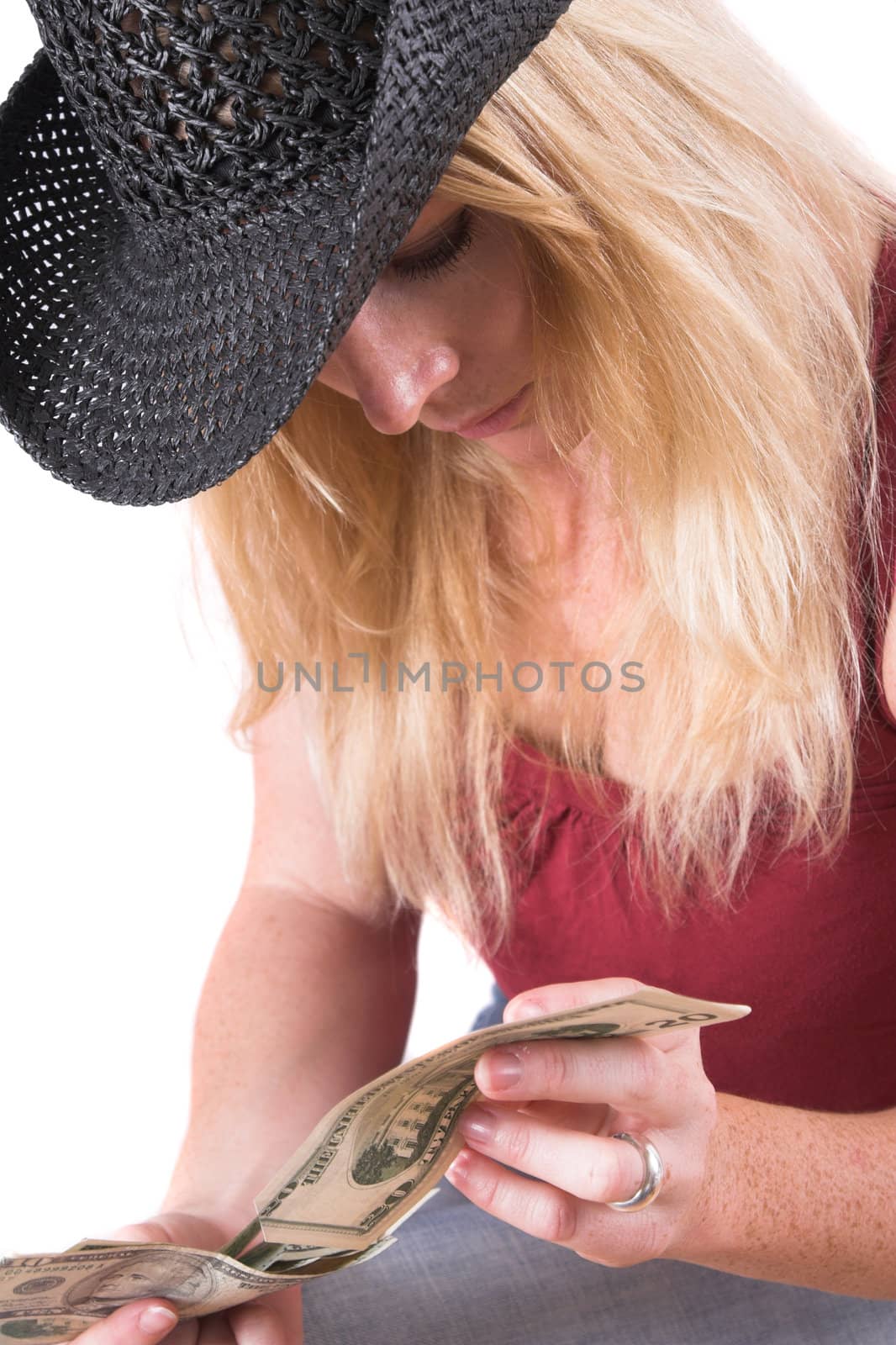 Woman looking curiously at the money in her hands