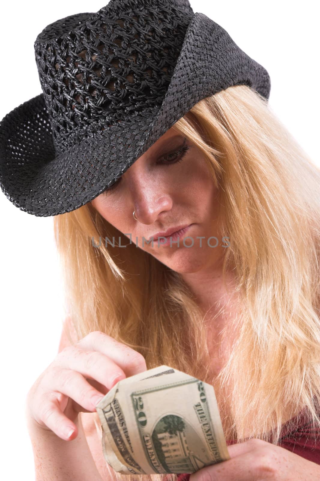 Pretty blond woman with black cowboyhat counting the dollars in her hand