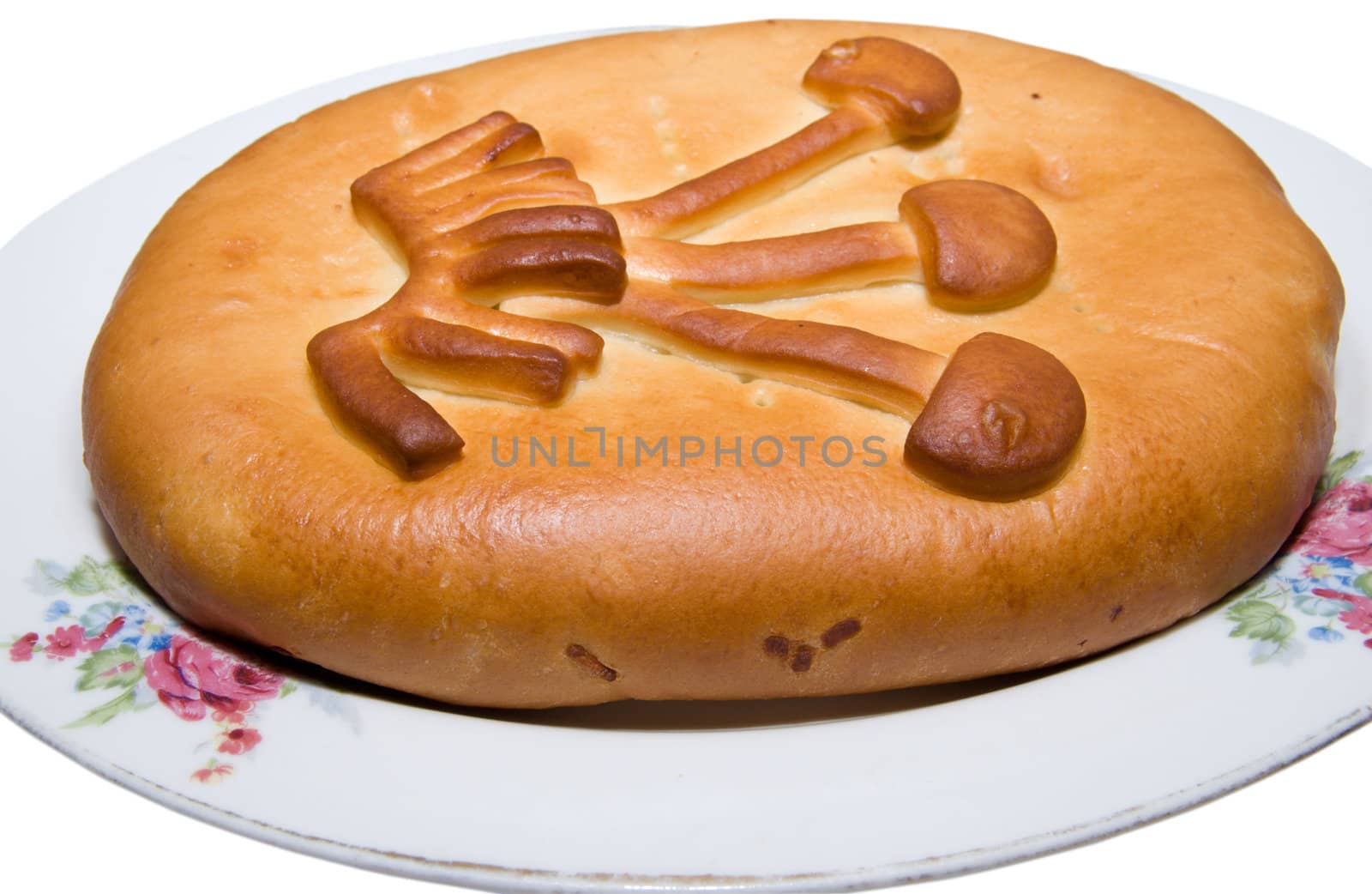The celebratory pie lays on a plate, isolated on a white background.