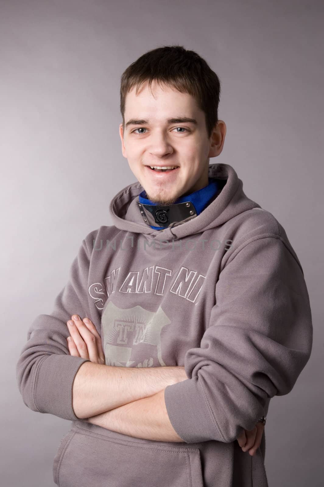 The young guy in studio on a grey background