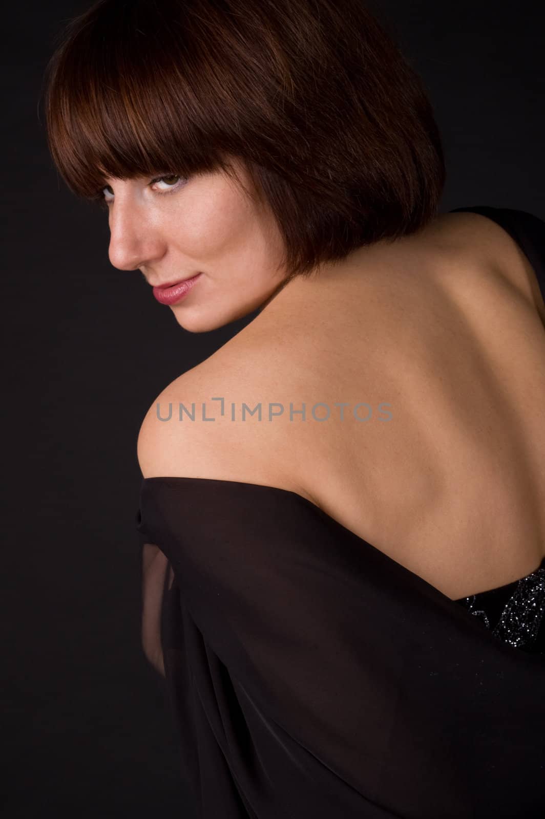 The woman in a dress on a black background