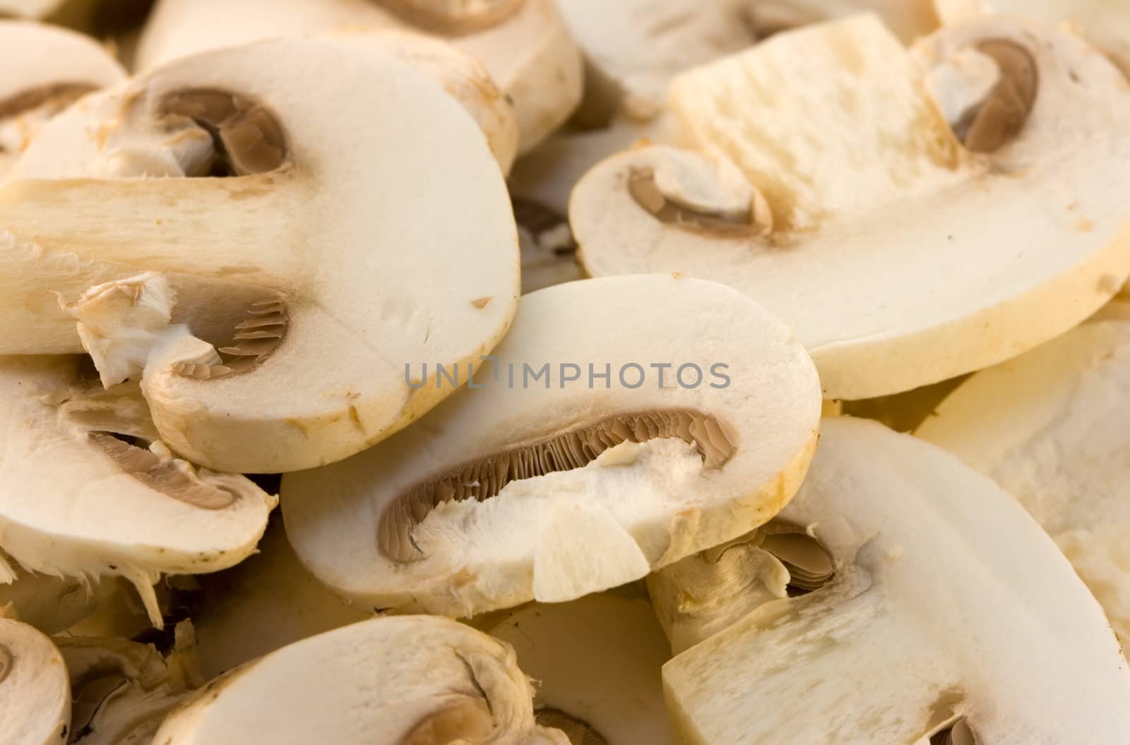 Close-up of fresh champignon slices on isolated background