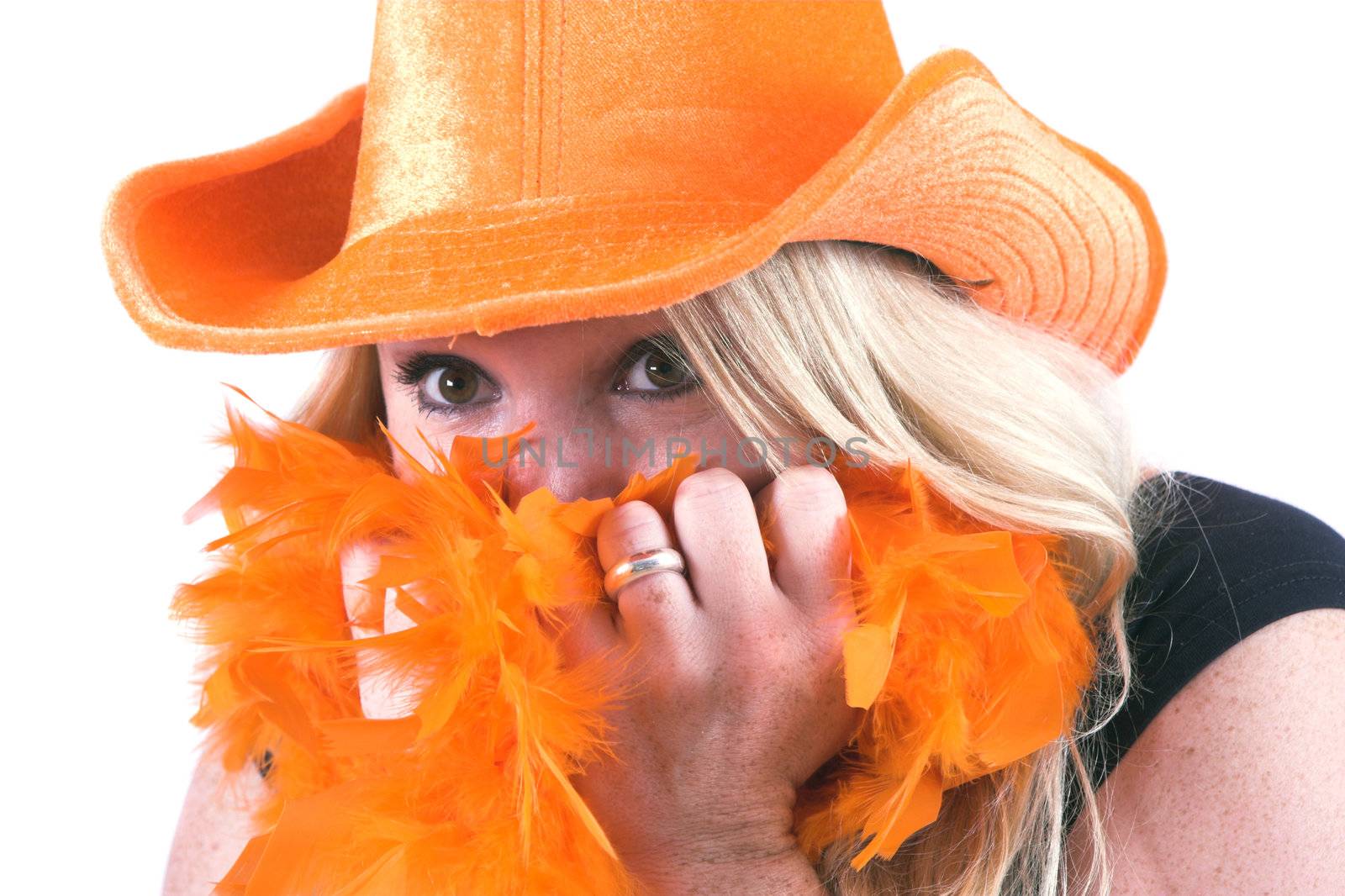 Blond woman hiding in her orange boa while watching an exciting football game