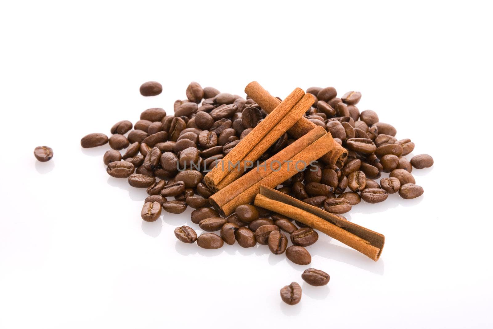 Isolated brown coffee beans and cinnamon sticks