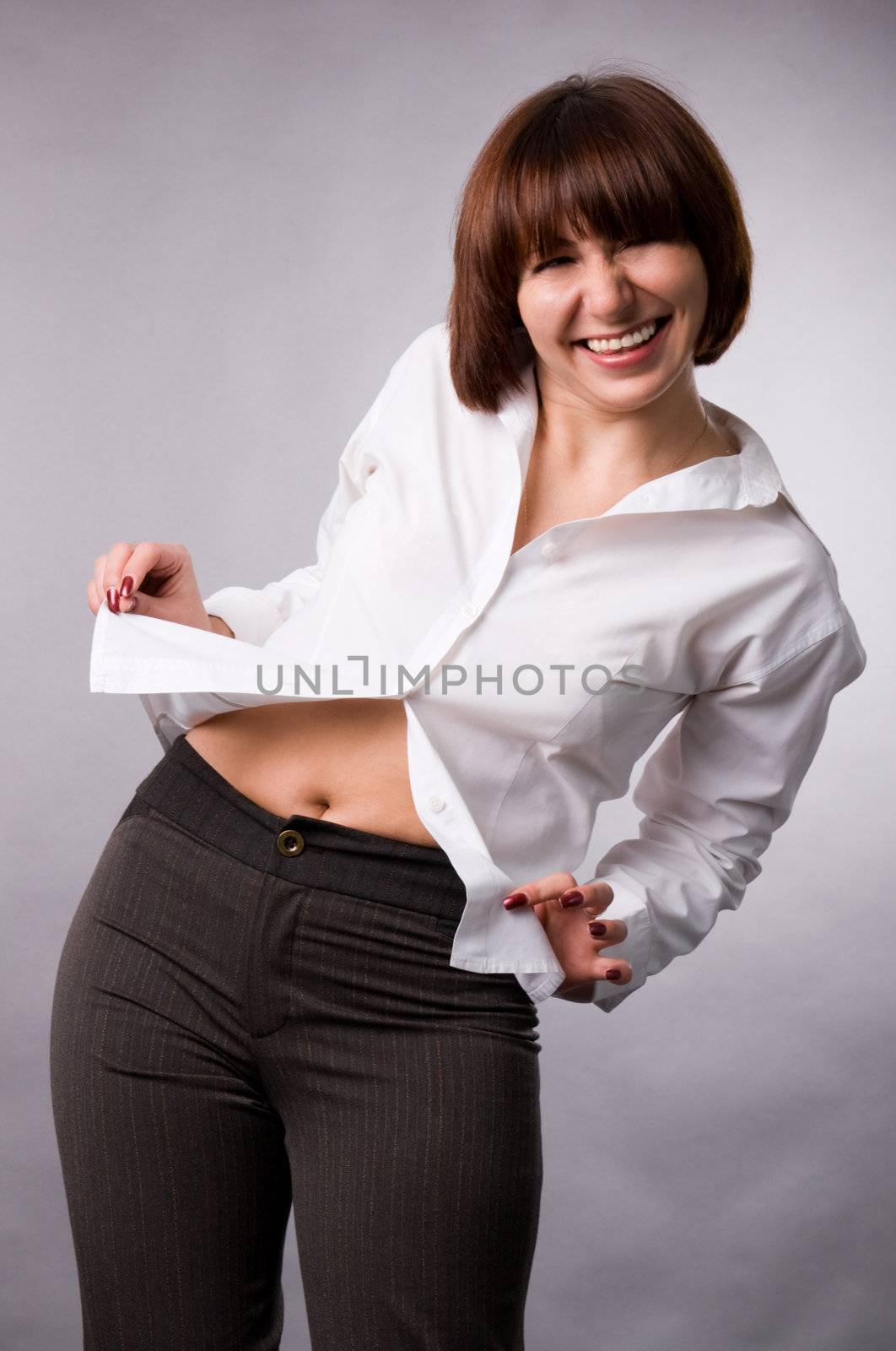 The woman in a white shirt on a grey background