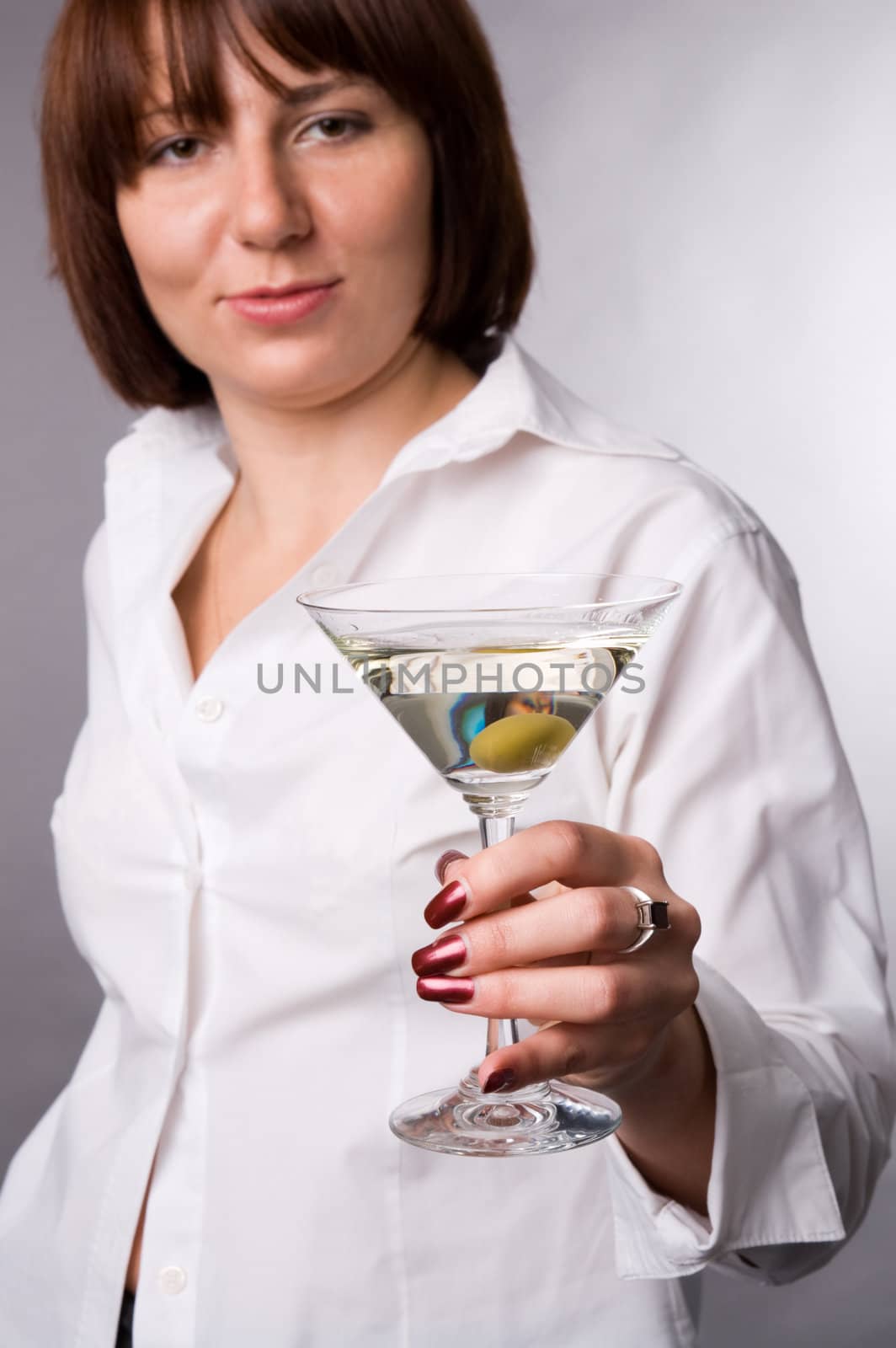 The woman in a white shirt with a glass of martini