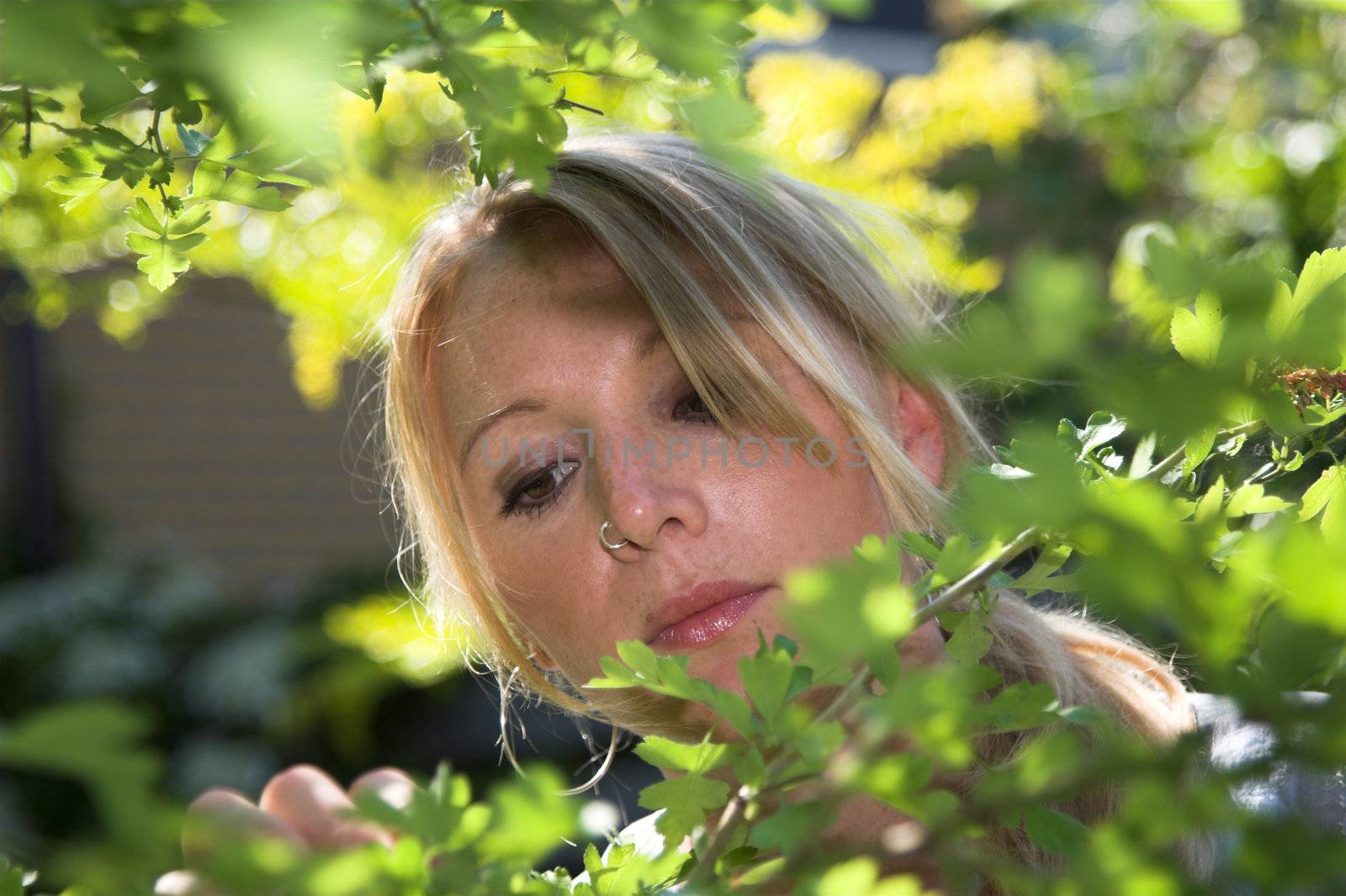 Pretty blond girl working in the garden