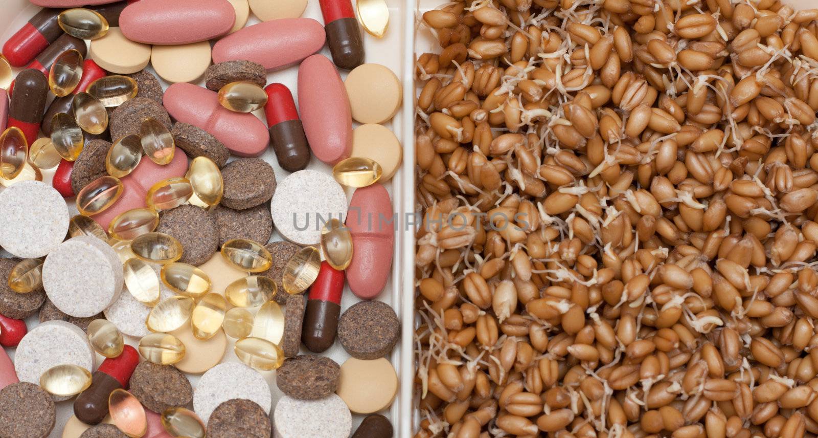 Container with pill, tablet and wheat on white background