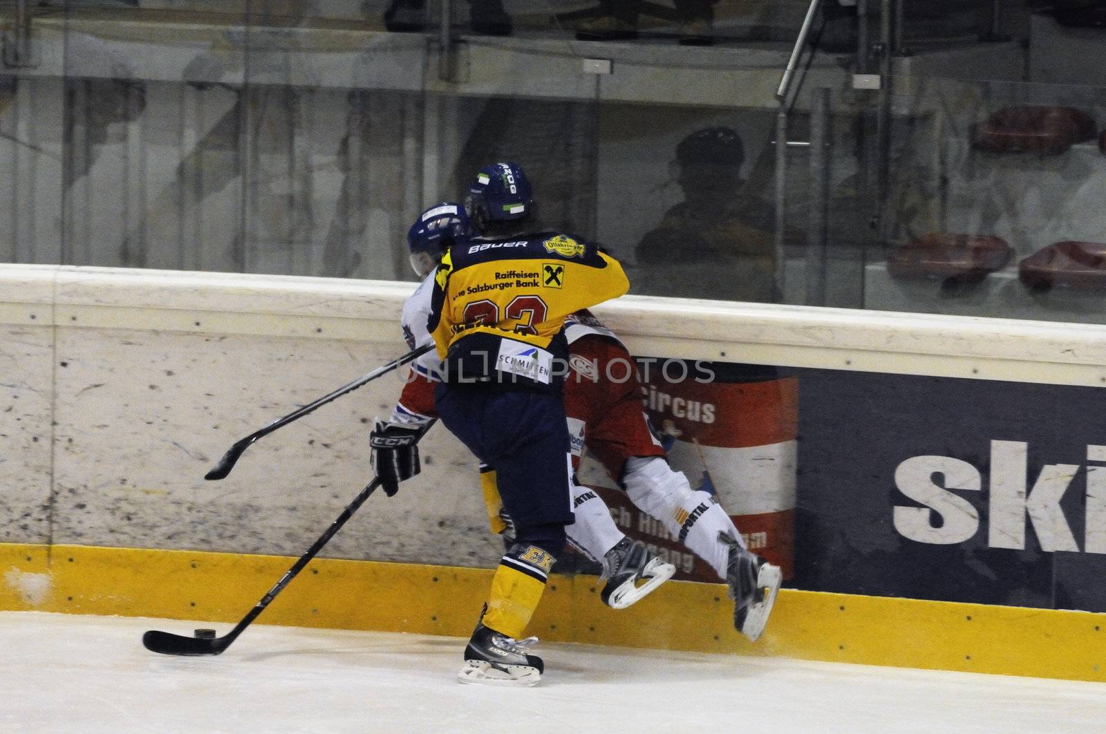 ZELL AM SEE, AUSTRIA - NOVEMBER 30: Austrian National League. Graz player gets hit. Game EK Zell am See vs. ATSE Graz (Result 0-4) on November 30, 2010, at hockey rink of Zell am See