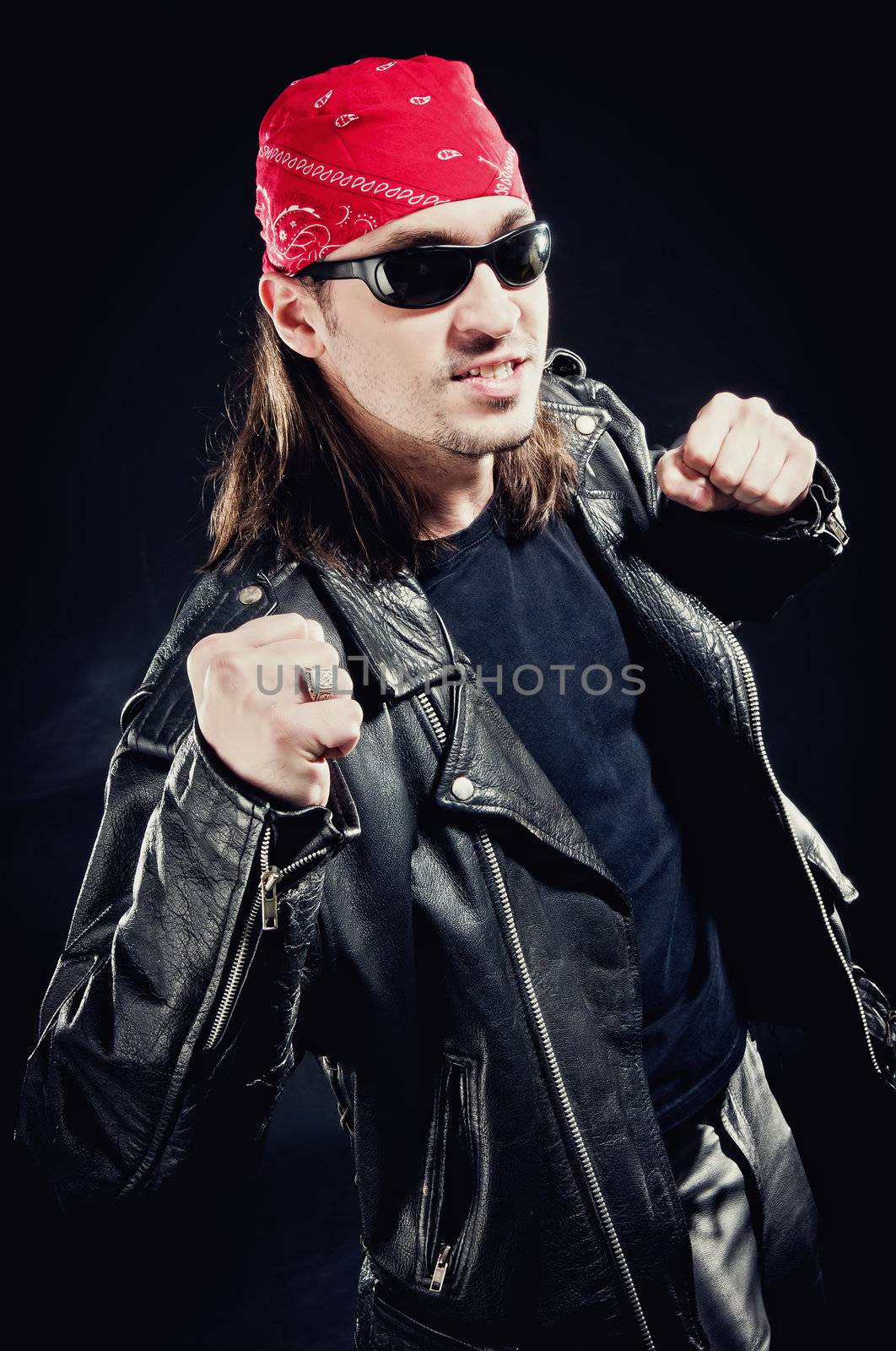 Rock star wearing a leather jacket and red bandana 