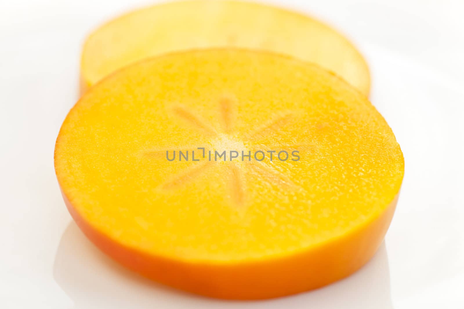 Persimmon slice on white background with clipping path.