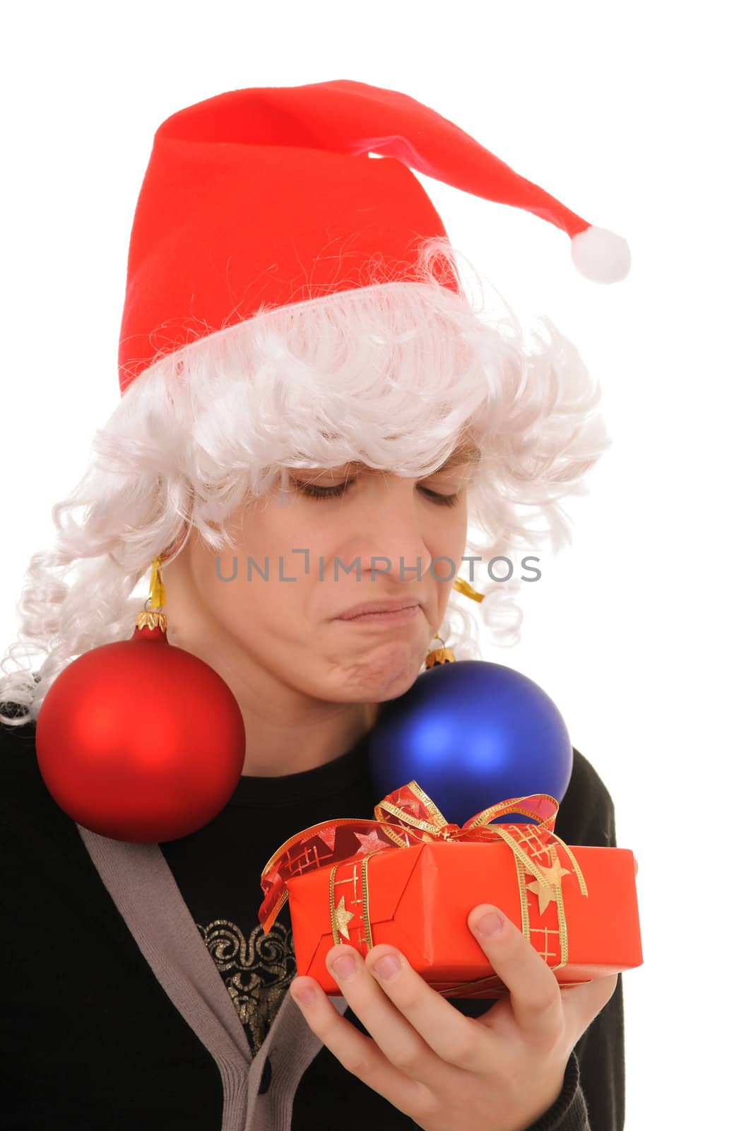 teenager in hat santa claus  and the spheres in ears isolated on white background