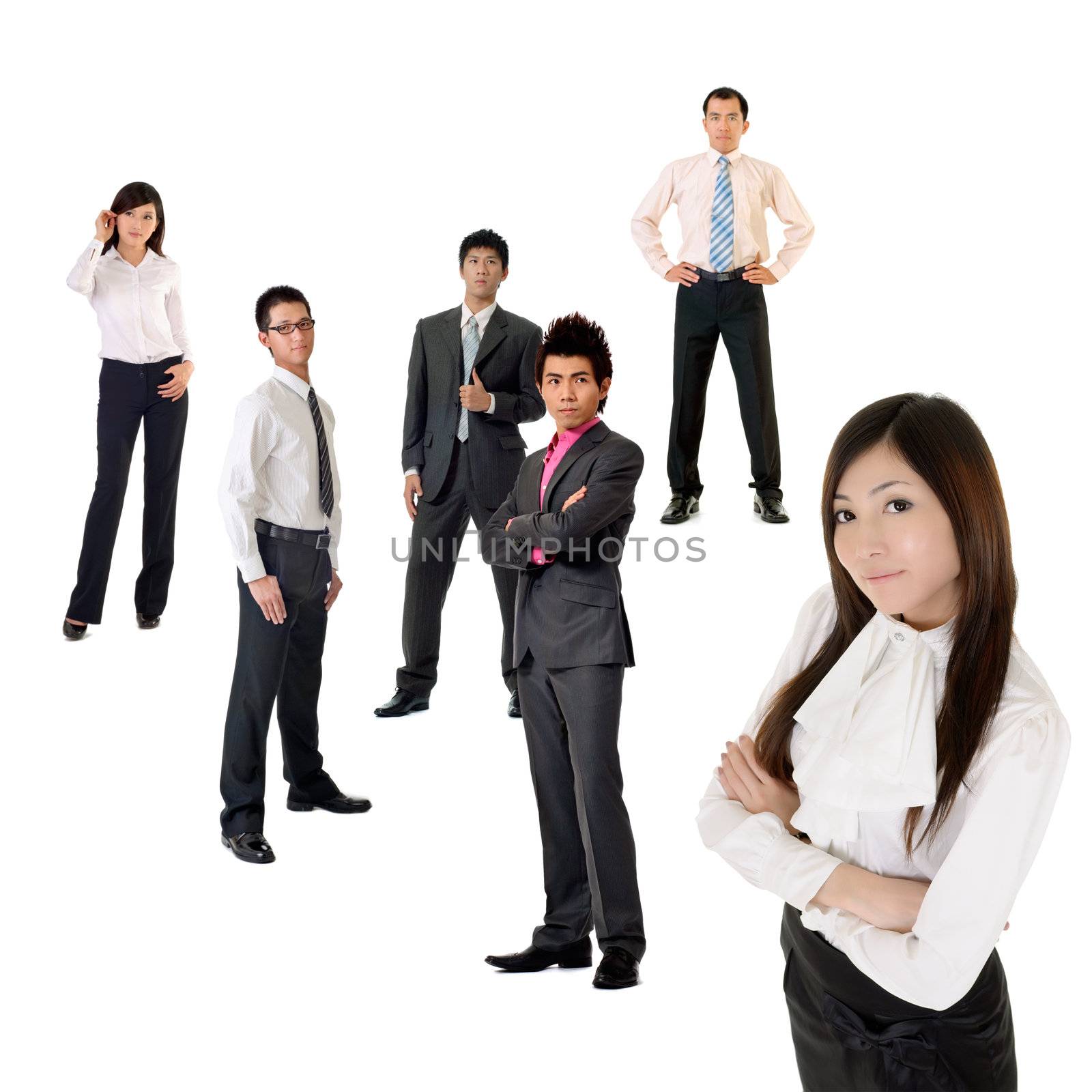 Young business woman and her team over white background, focus on woman in front.