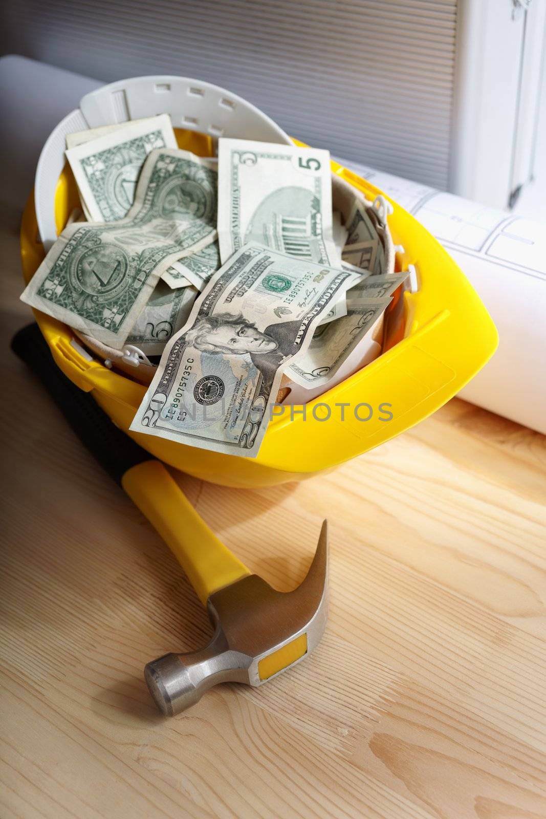 financial concept with dollars and yellow hardhat, selective focus