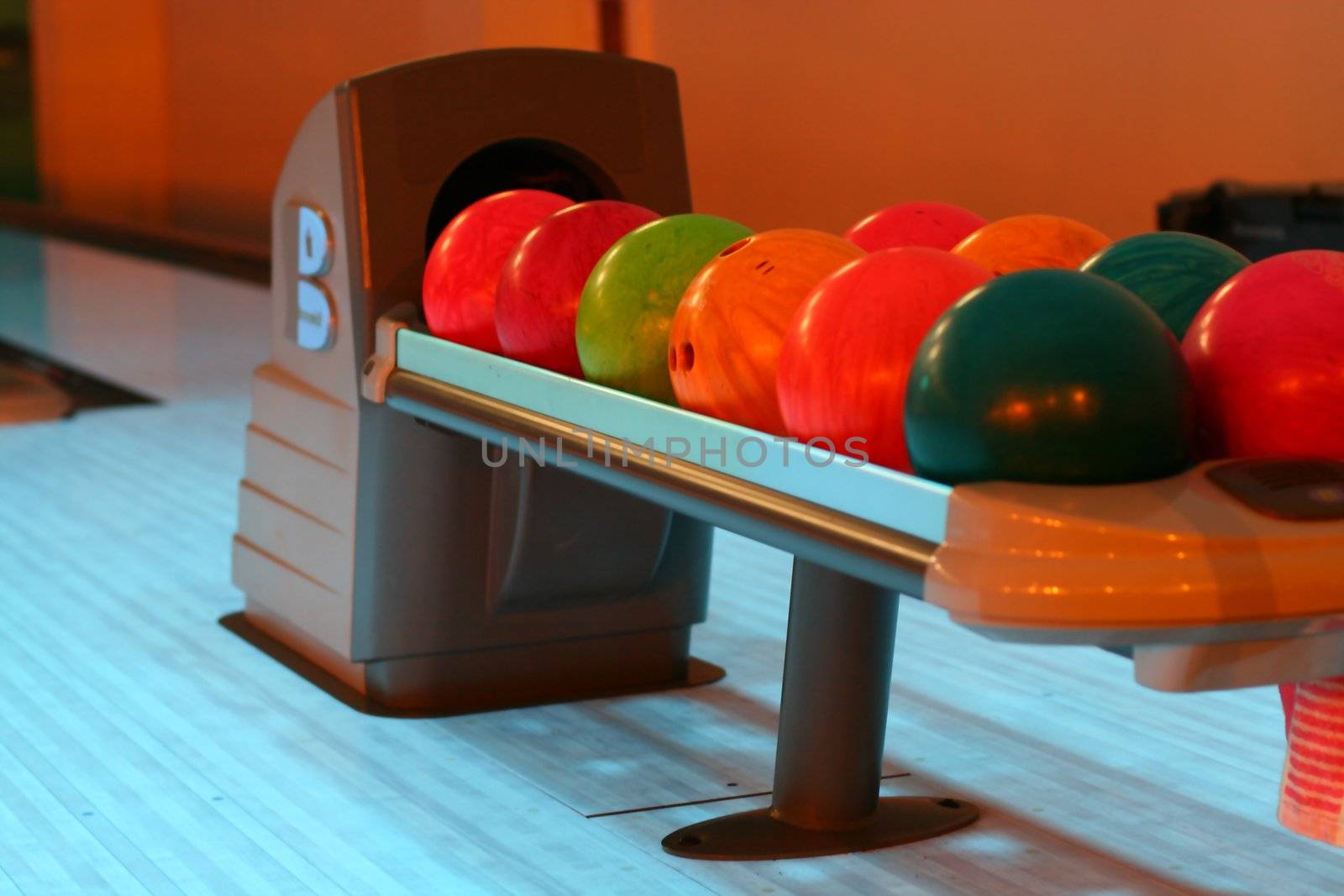 colored bowling bolls in a row 