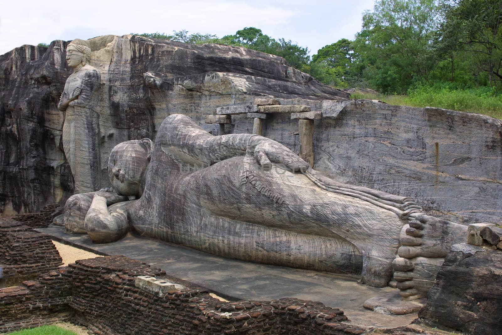 The Reclining and Standing Buddhas were carved out of a granite cliff at Gal Vihariya in Pollanaruwa, Sri Lanka. They are part of one of the most important Buddhist shrines in the world and also a part of a UNESCO World Heritage Site.