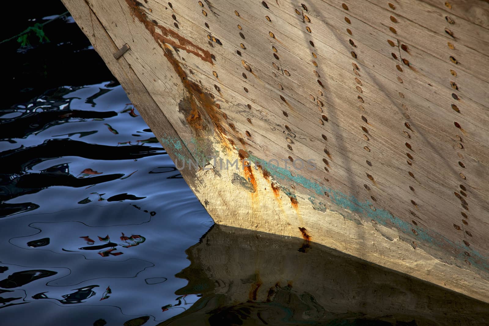 The bow of a traditional wooden trading dhow moored in Dubai Creek, UAE.
