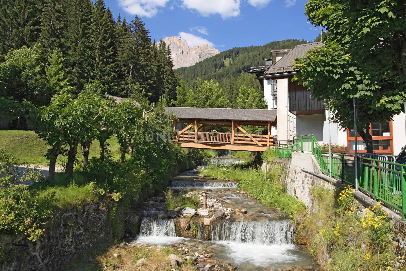 Small stream with amazing bridge in Canazei, val di fassa, Italy